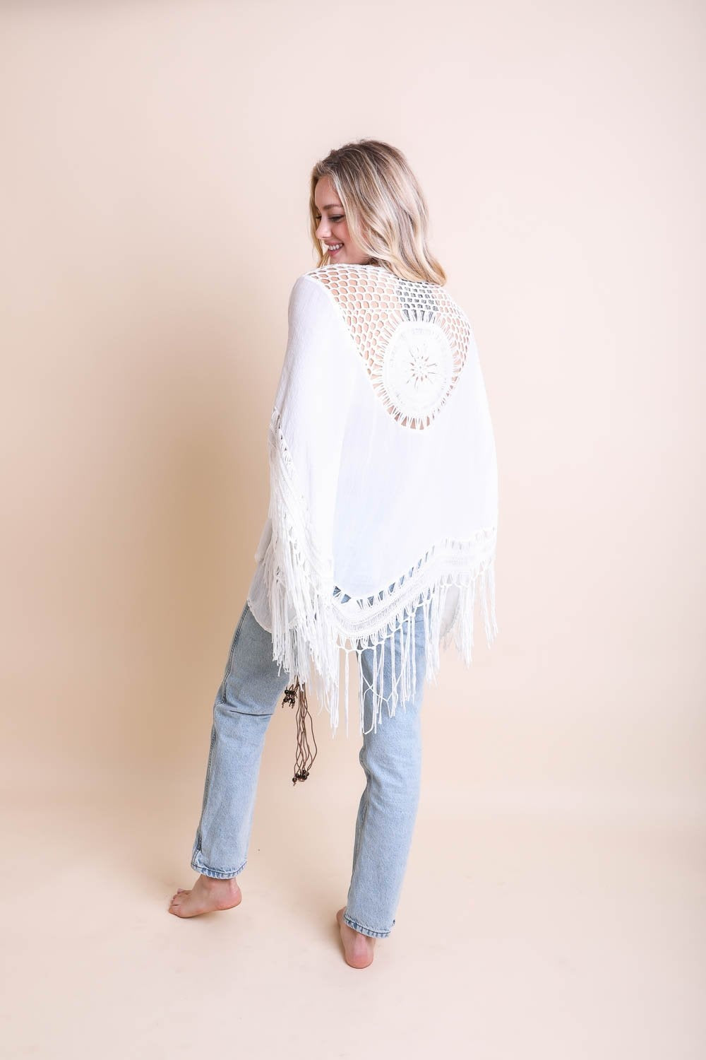 A lightweight Crochet Medallion Tassel Kimono featuring intricate crochet patterns and tassels, perfect for a bohemian look.