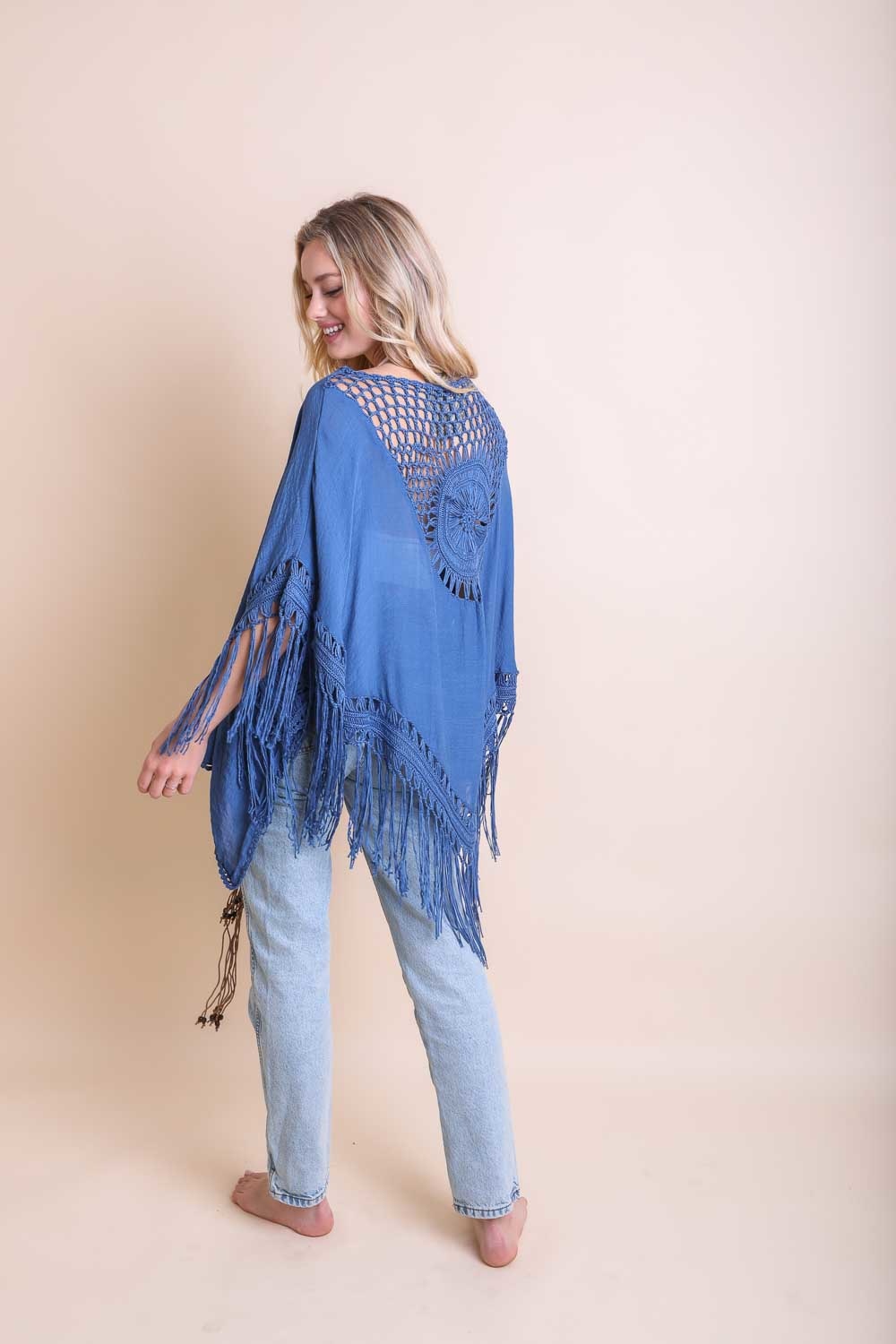 A lightweight Crochet Medallion Tassel Kimono featuring intricate crochet patterns and tassels, perfect for a bohemian look.