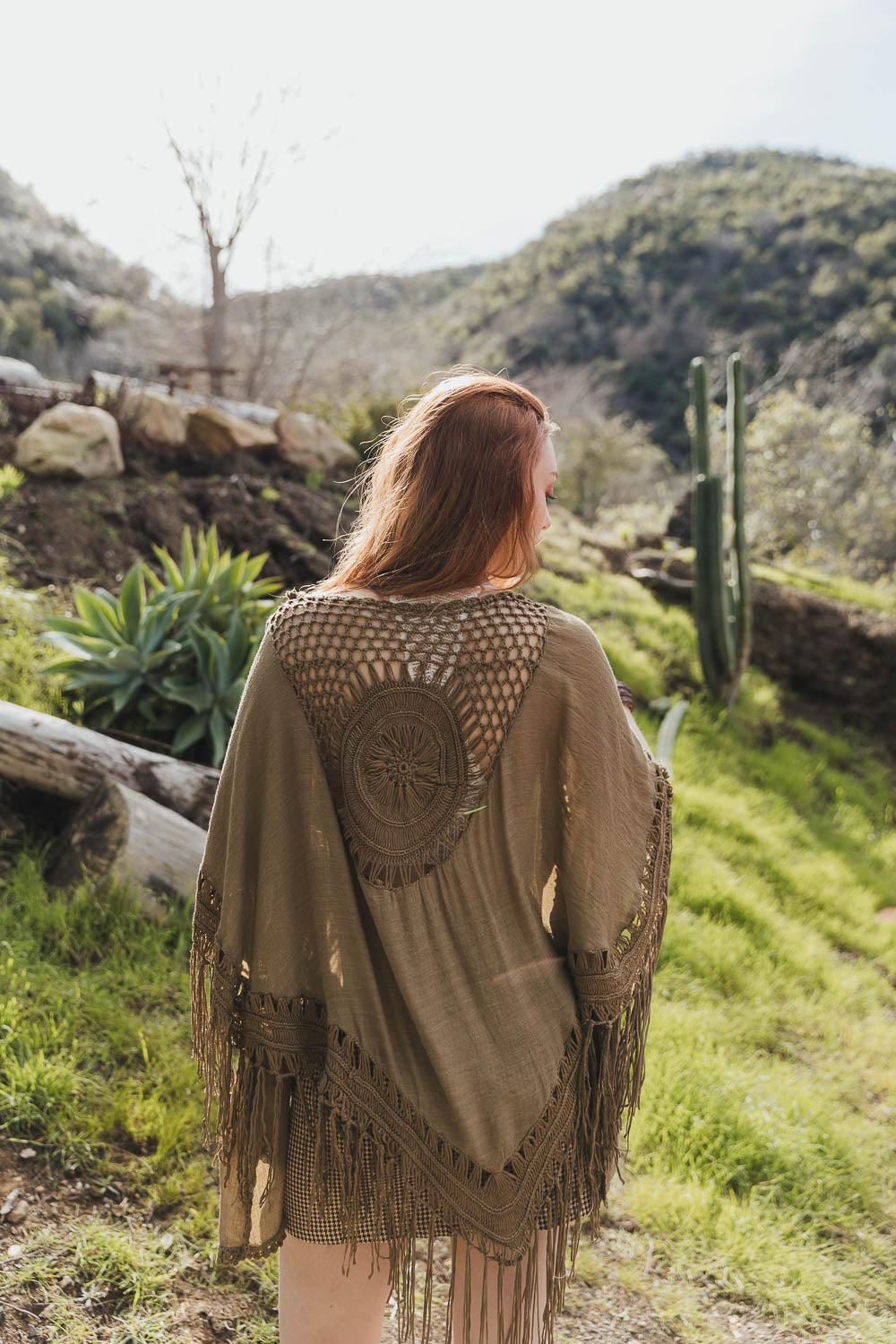 A lightweight Crochet Medallion Tassel Kimono featuring intricate crochet patterns and tassels, perfect for a bohemian look.