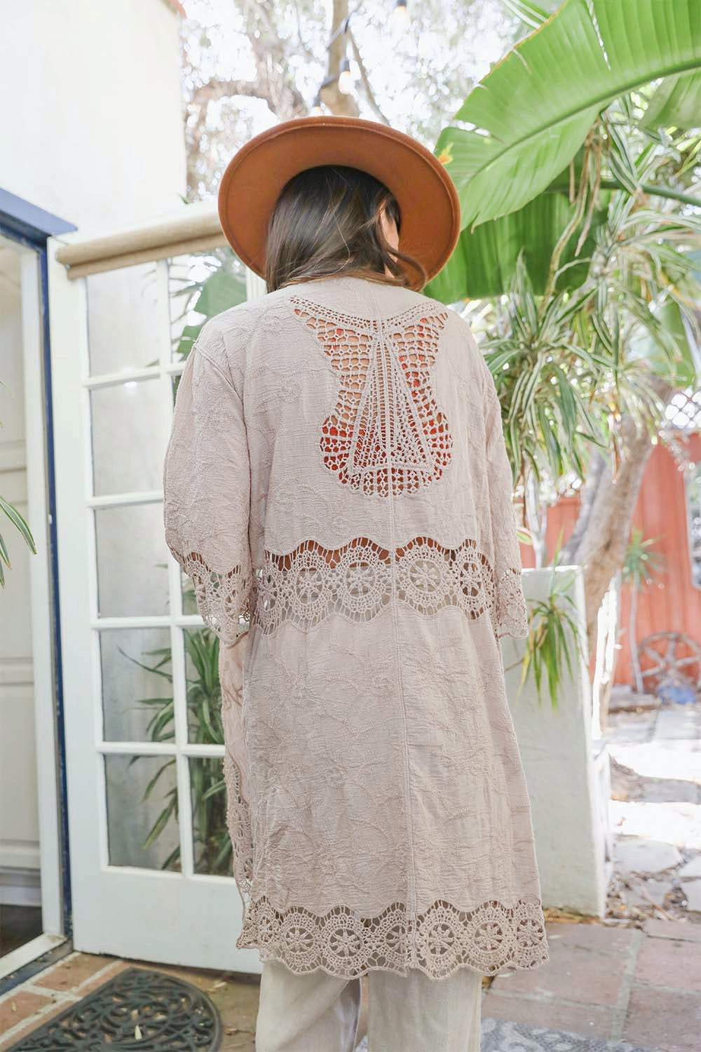 A lightweight crochet open patch kimono in a stylish design, perfect for layering over outfits.