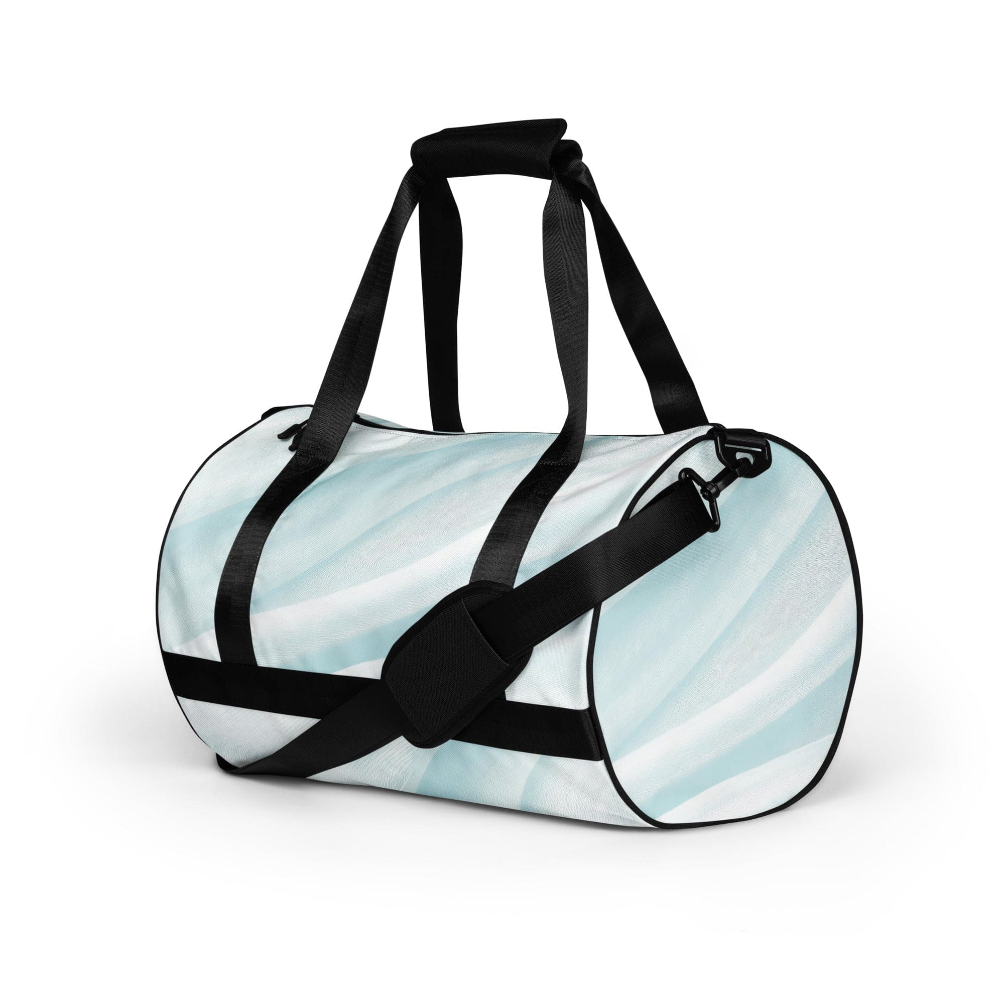 Crossbody water-resistant travel bag in pastel blue swirl, featuring dual padded handles and multiple pockets for organization.