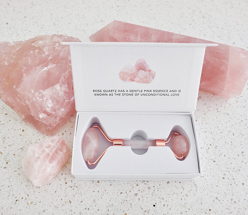 A beautiful Crystal Facial Roller made of Amethyst and Rose Quartz, designed for skincare and relaxation.