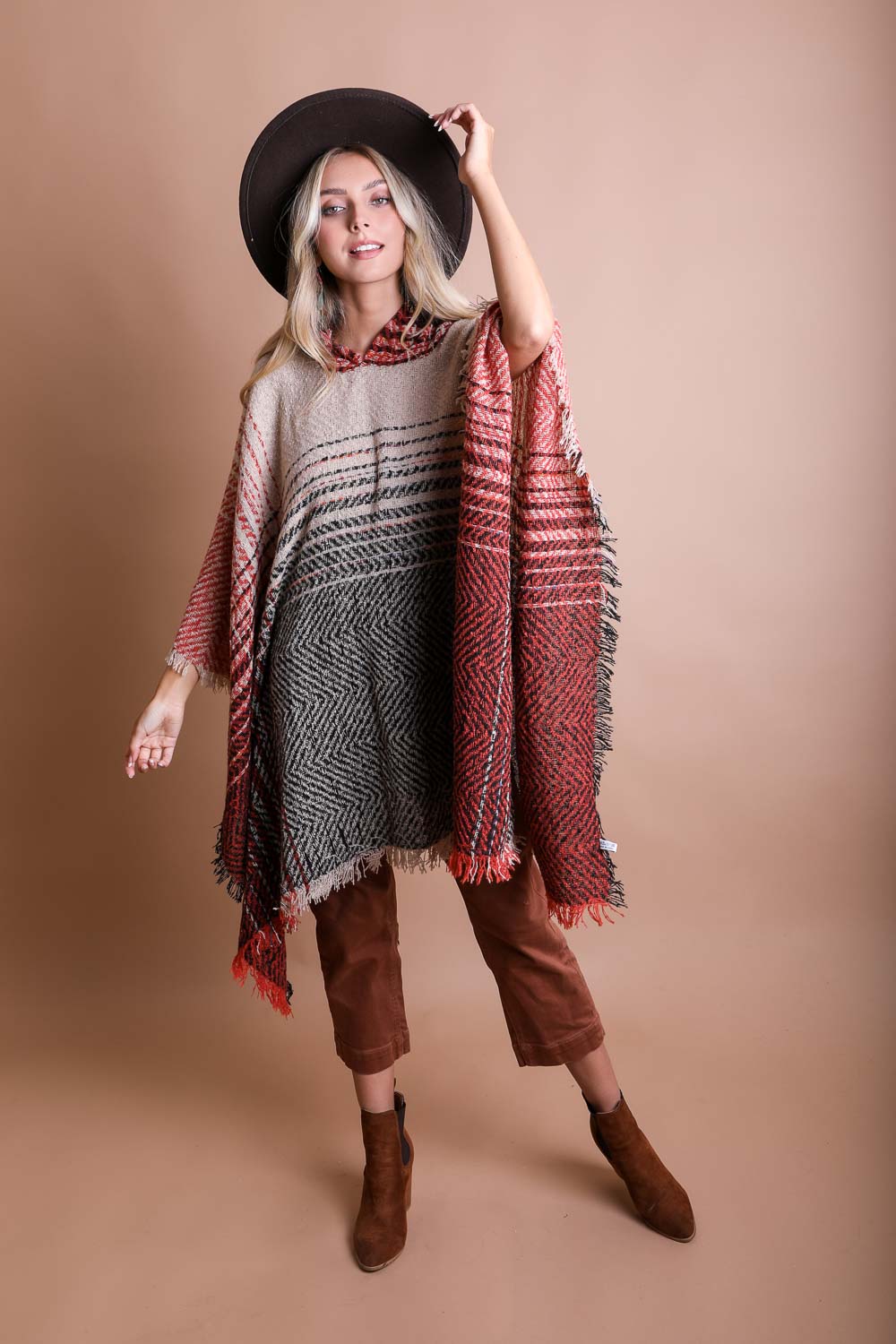 A cozy Cuddly Herringbone Hooded Poncho featuring a stylish herringbone pattern and a cute hood, perfect for chilly weather.