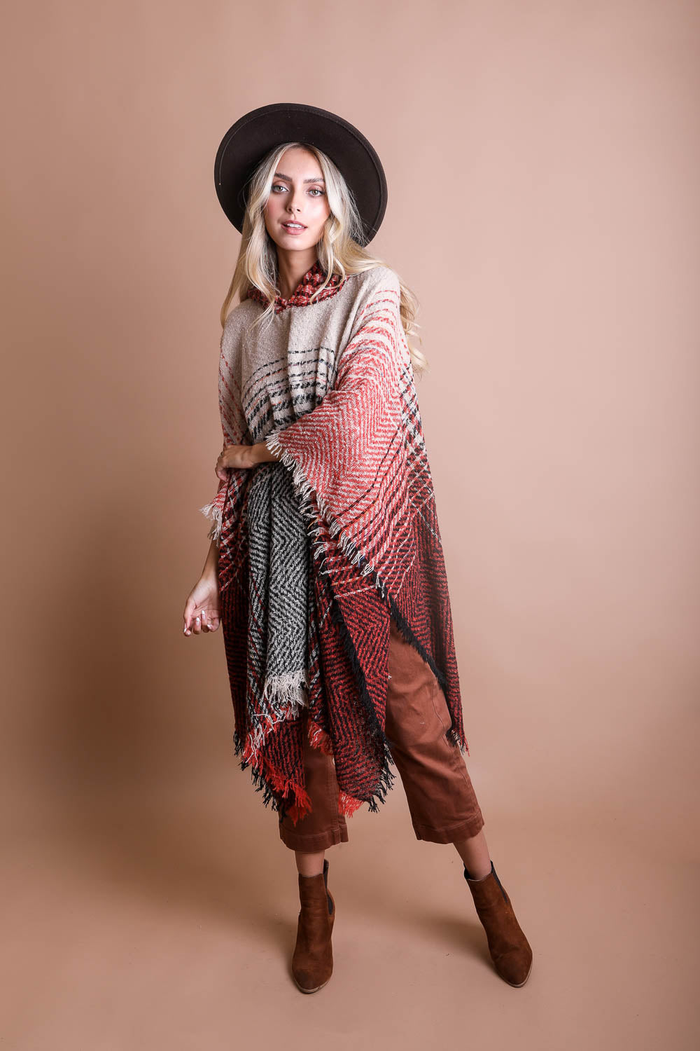 A cozy Cuddly Herringbone Hooded Poncho featuring a stylish herringbone pattern and a cute hood, perfect for chilly weather.