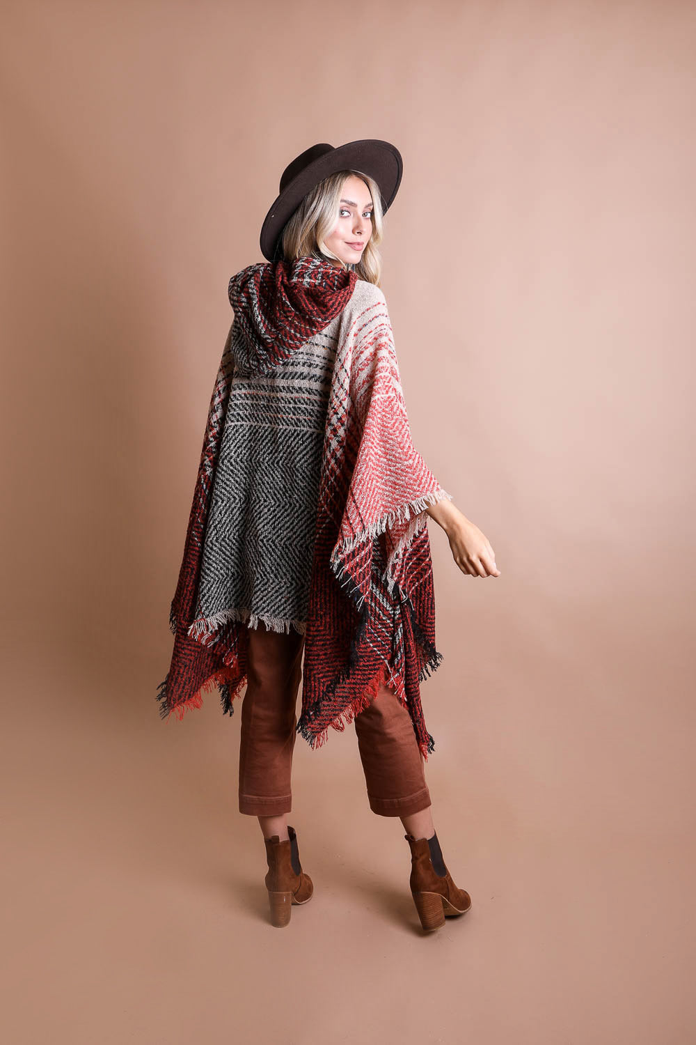 A cozy Cuddly Herringbone Hooded Poncho featuring a stylish herringbone pattern and a cute hood, perfect for chilly weather.