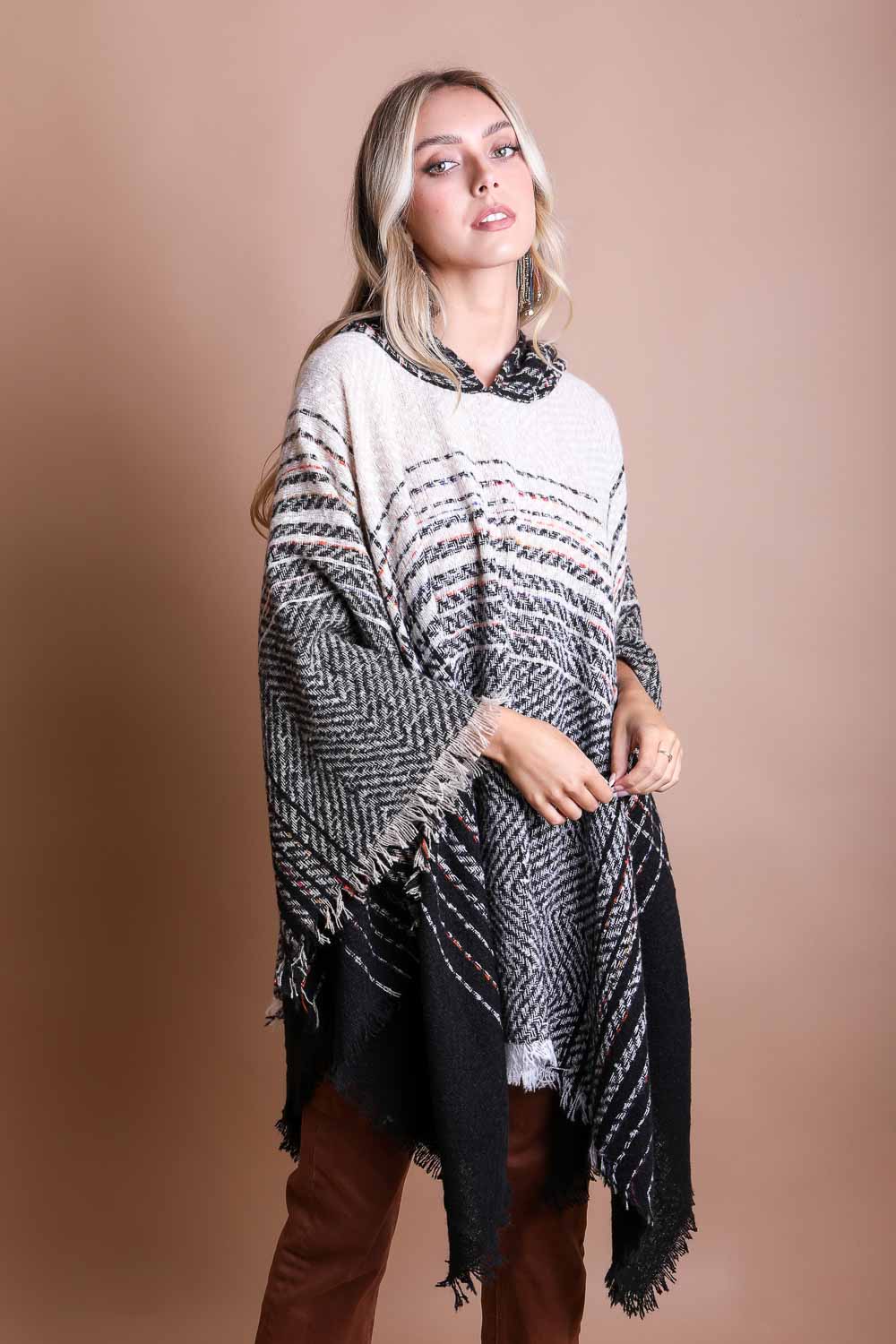 A cozy Cuddly Herringbone Hooded Poncho featuring a stylish herringbone pattern and a cute hood, perfect for chilly weather.