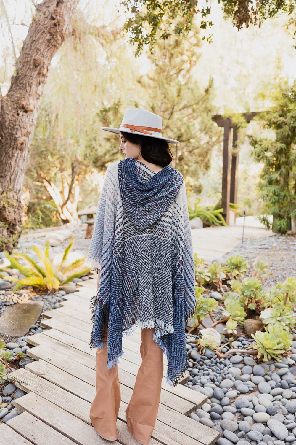 A cozy Cuddly Herringbone Hooded Poncho featuring a stylish herringbone pattern and a cute hood, perfect for chilly weather.