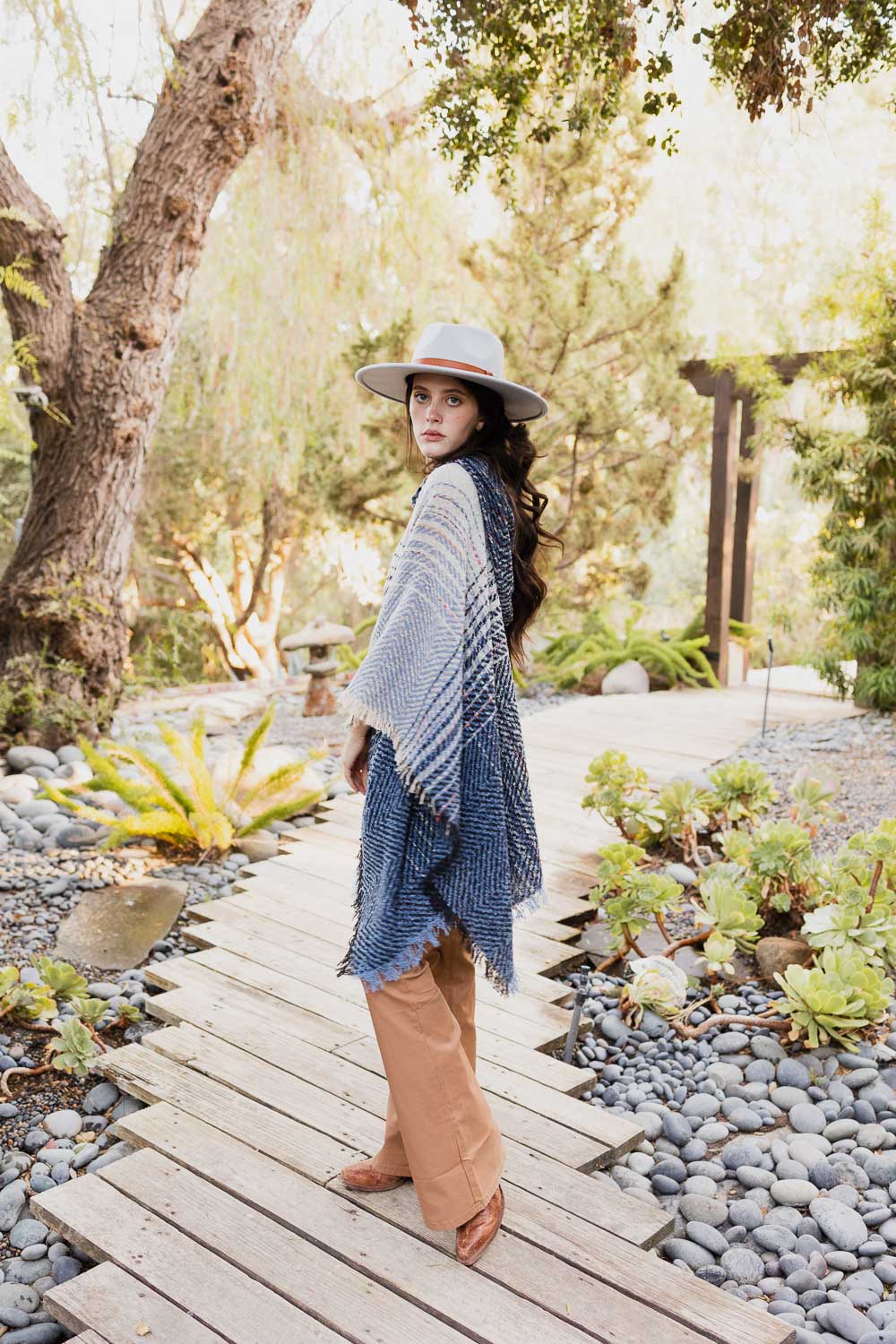 A cozy Cuddly Herringbone Hooded Poncho featuring a stylish herringbone pattern and a cute hood, perfect for chilly weather.