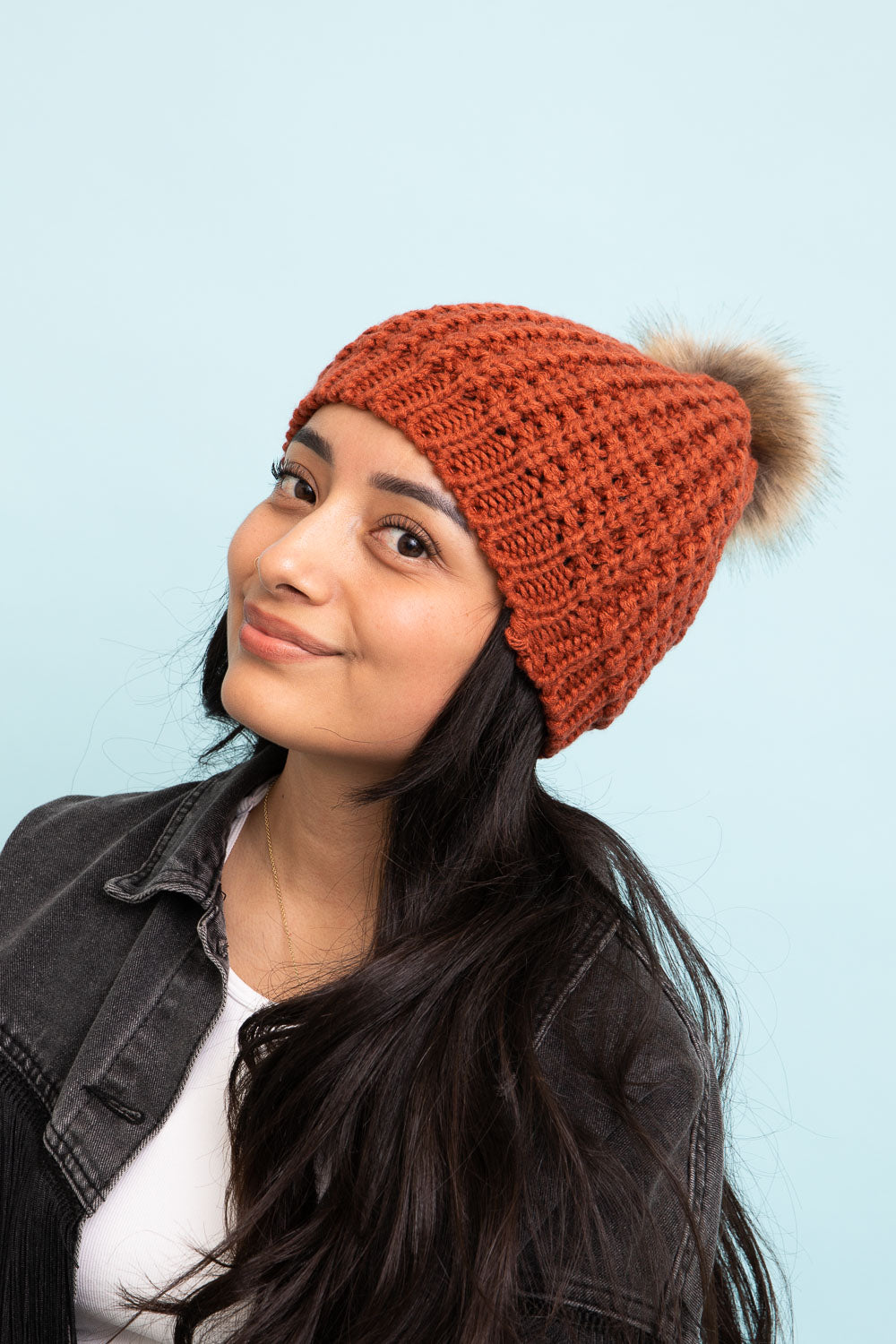 A cozy Cute Textured Pom Beanie featuring a stylish pom on top, perfect for winter wear.