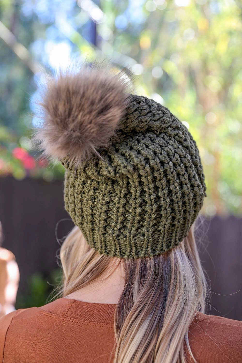 A cozy Cute Textured Pom Beanie featuring a stylish pom on top, perfect for winter wear.