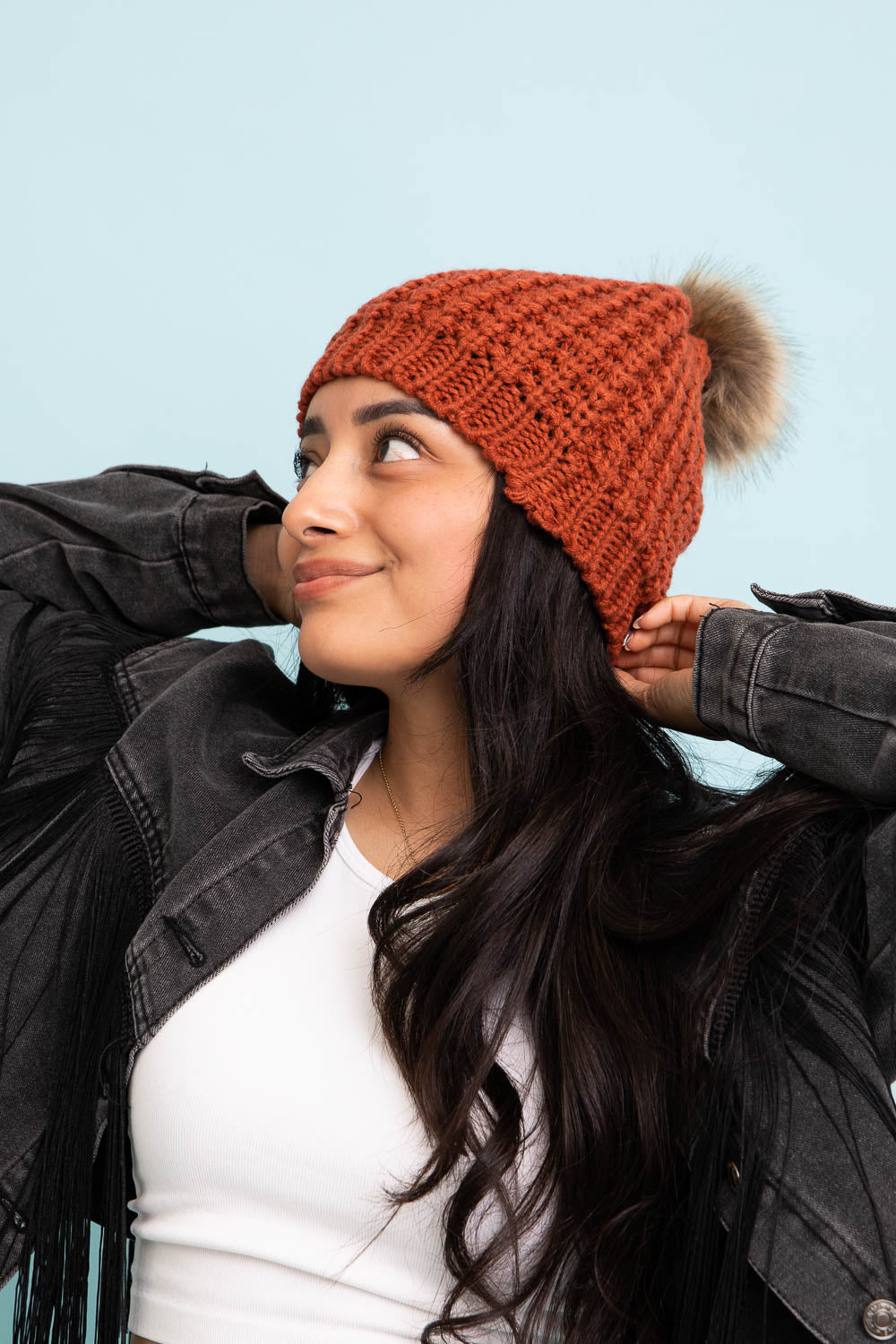 A cozy Cute Textured Pom Beanie featuring a stylish pom on top, perfect for winter wear.