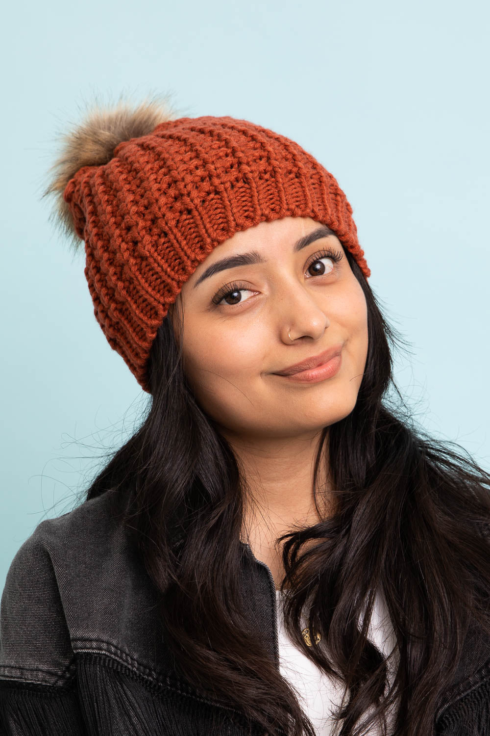 A cozy Cute Textured Pom Beanie featuring a stylish pom on top, perfect for winter wear.