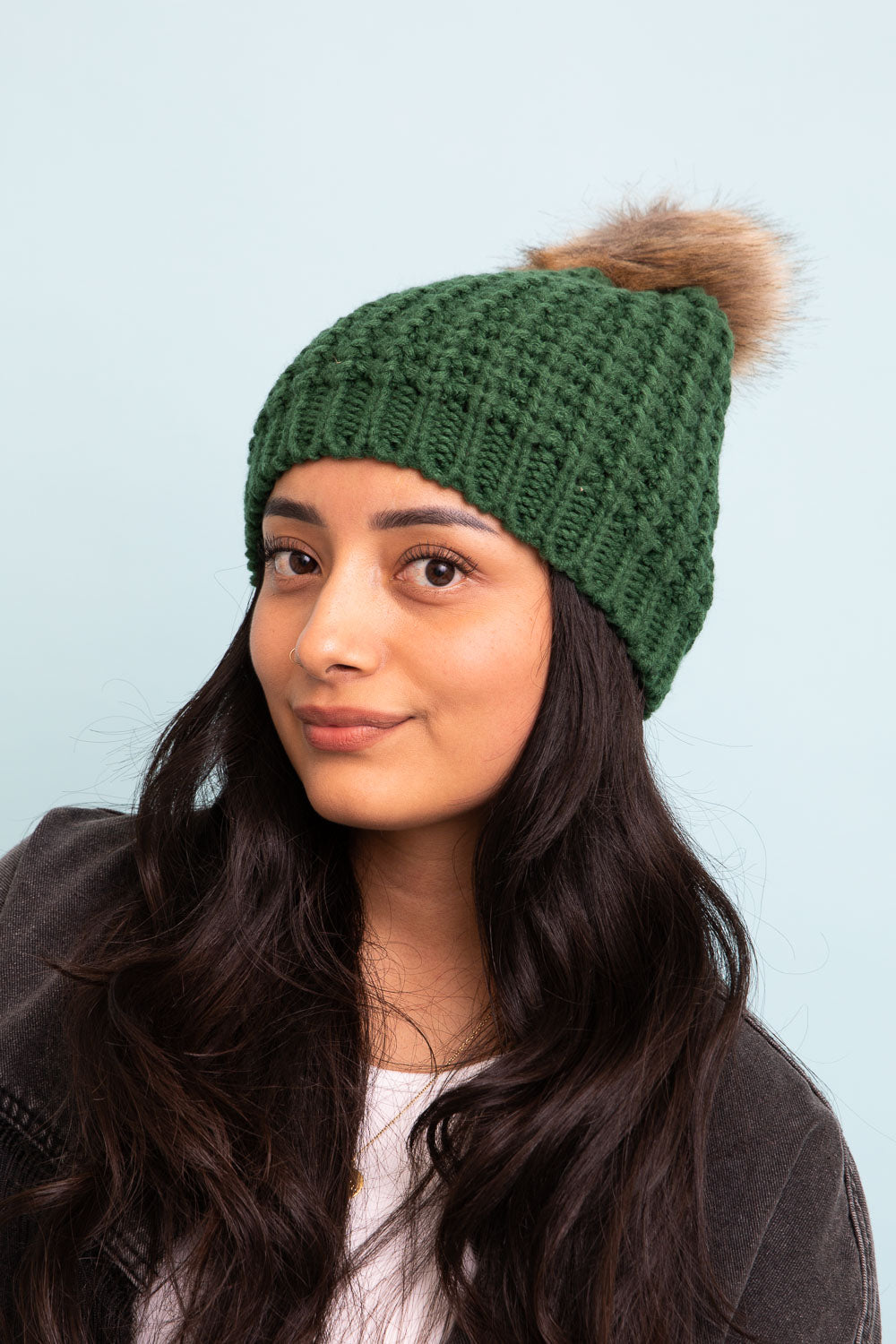 A cozy Cute Textured Pom Beanie featuring a stylish pom on top, perfect for winter wear.