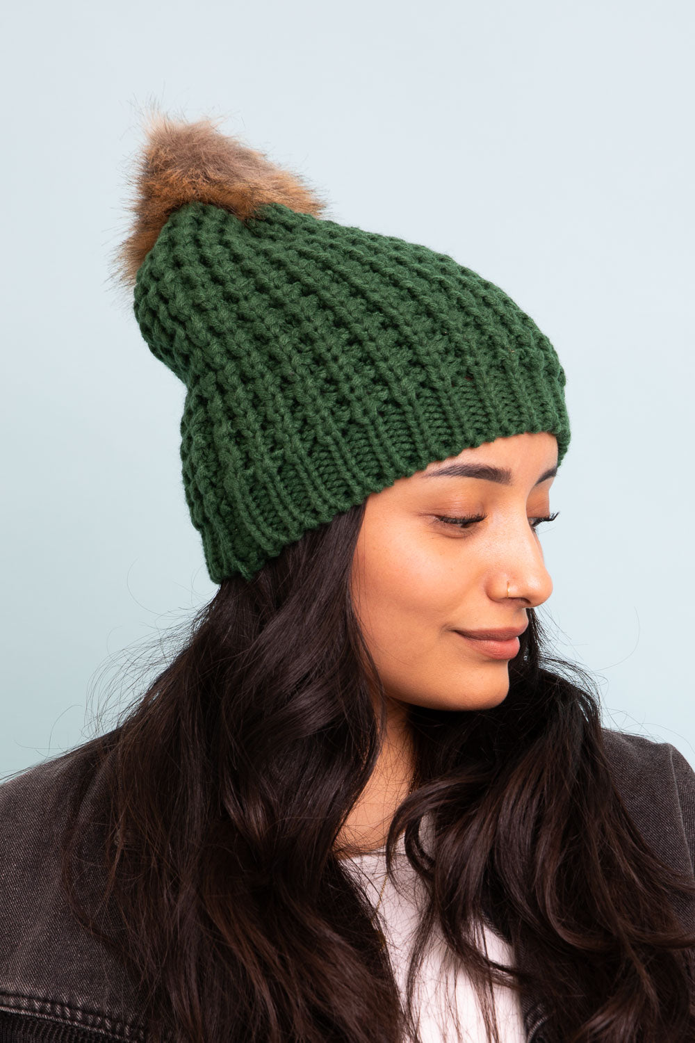 A cozy Cute Textured Pom Beanie featuring a stylish pom on top, perfect for winter wear.