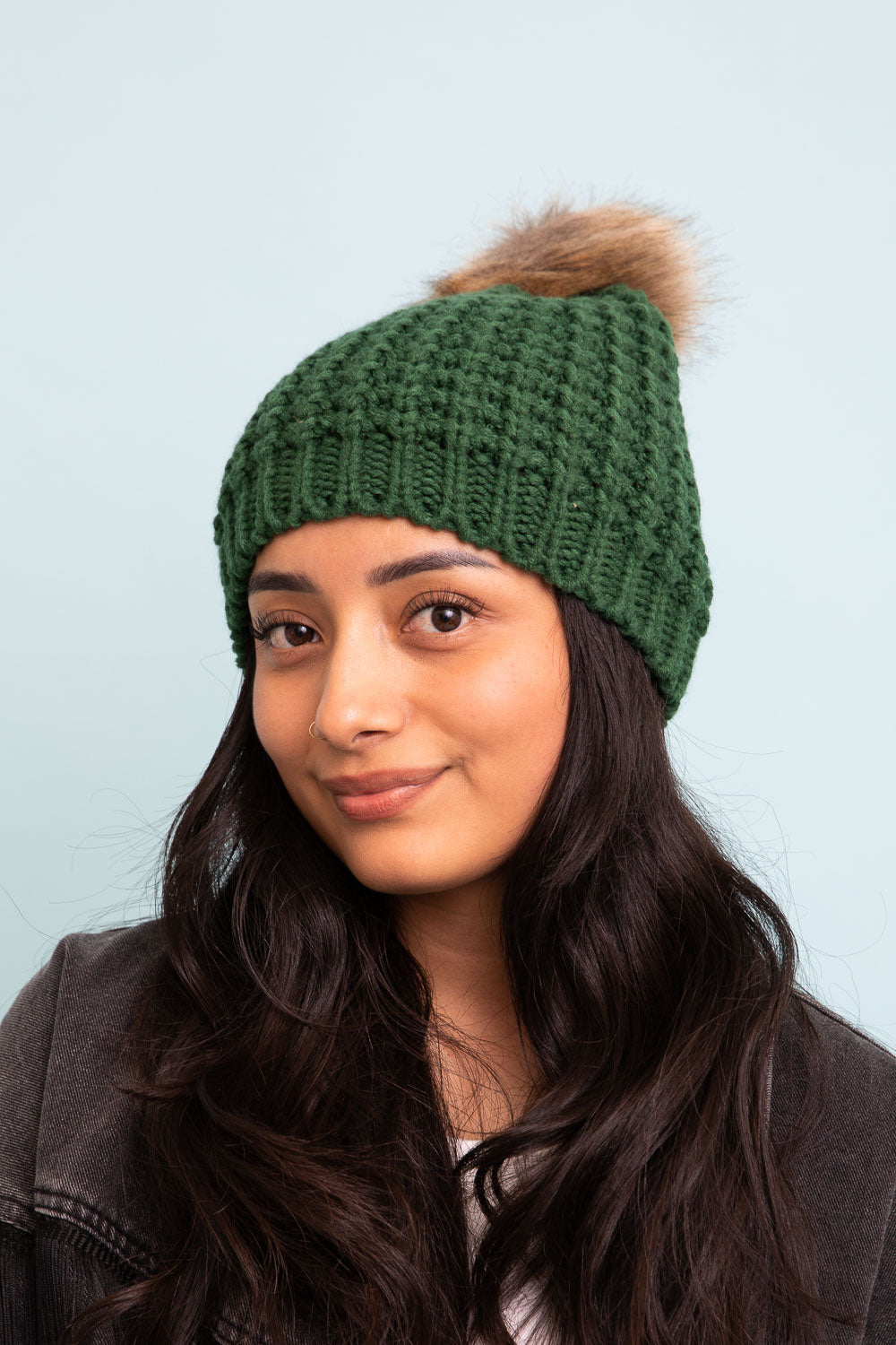 A cozy Cute Textured Pom Beanie featuring a stylish pom on top, perfect for winter wear.