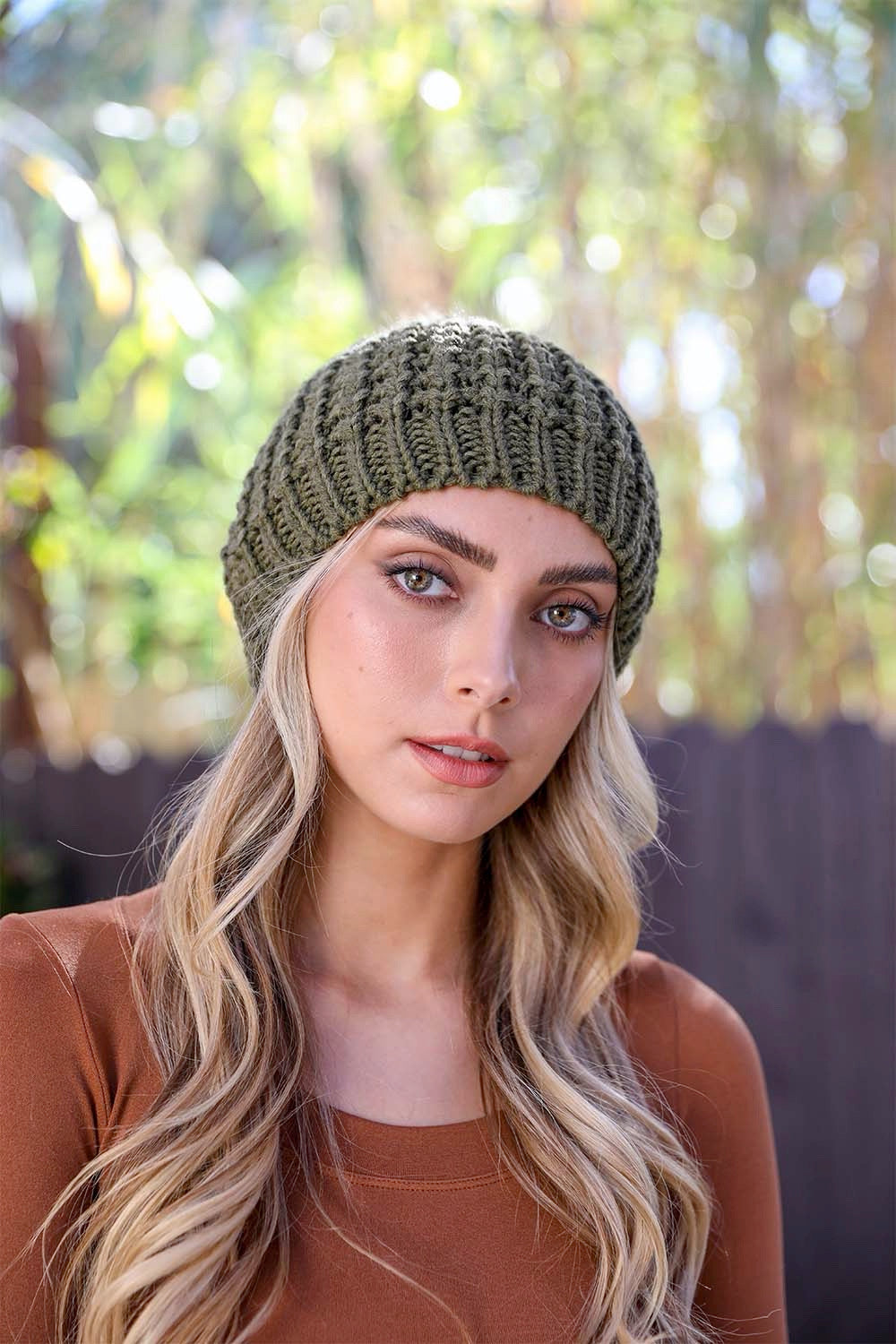 A cozy Cute Textured Pom Beanie featuring a stylish pom on top, perfect for winter wear.