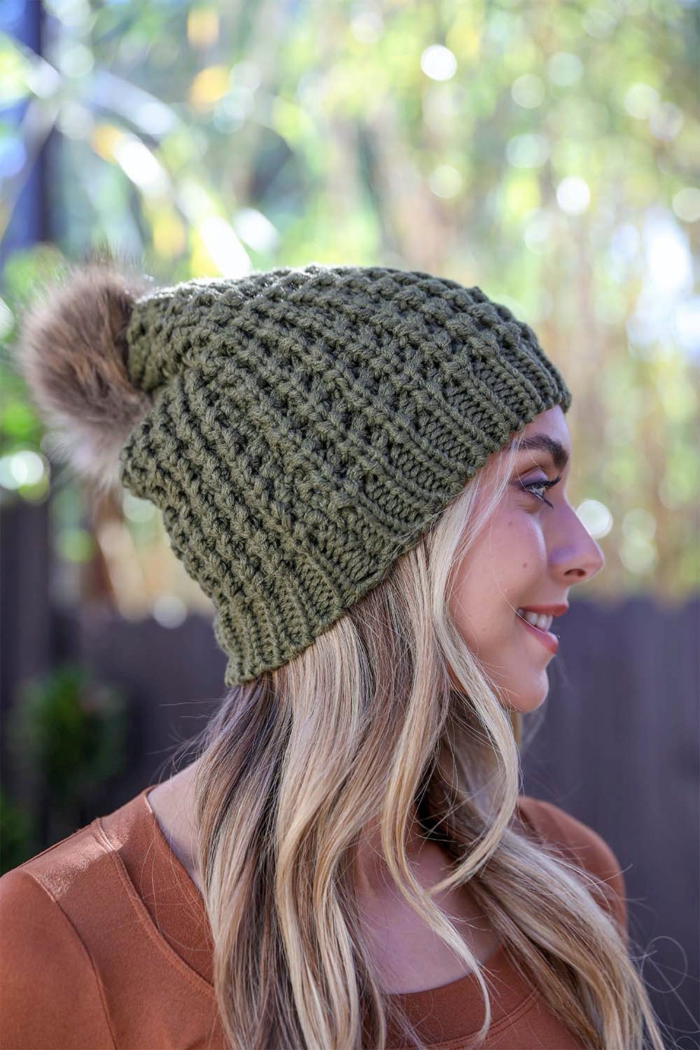 A cozy Cute Textured Pom Beanie featuring a stylish pom on top, perfect for winter wear.