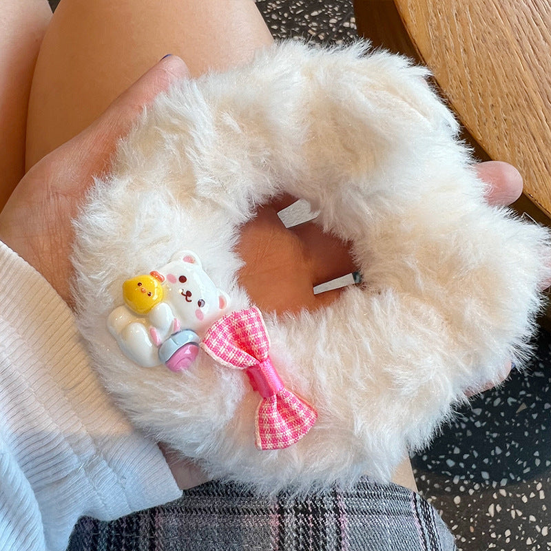 Cute white bear plush hair tie with a charming bow, perfect for adding style to any hairstyle.