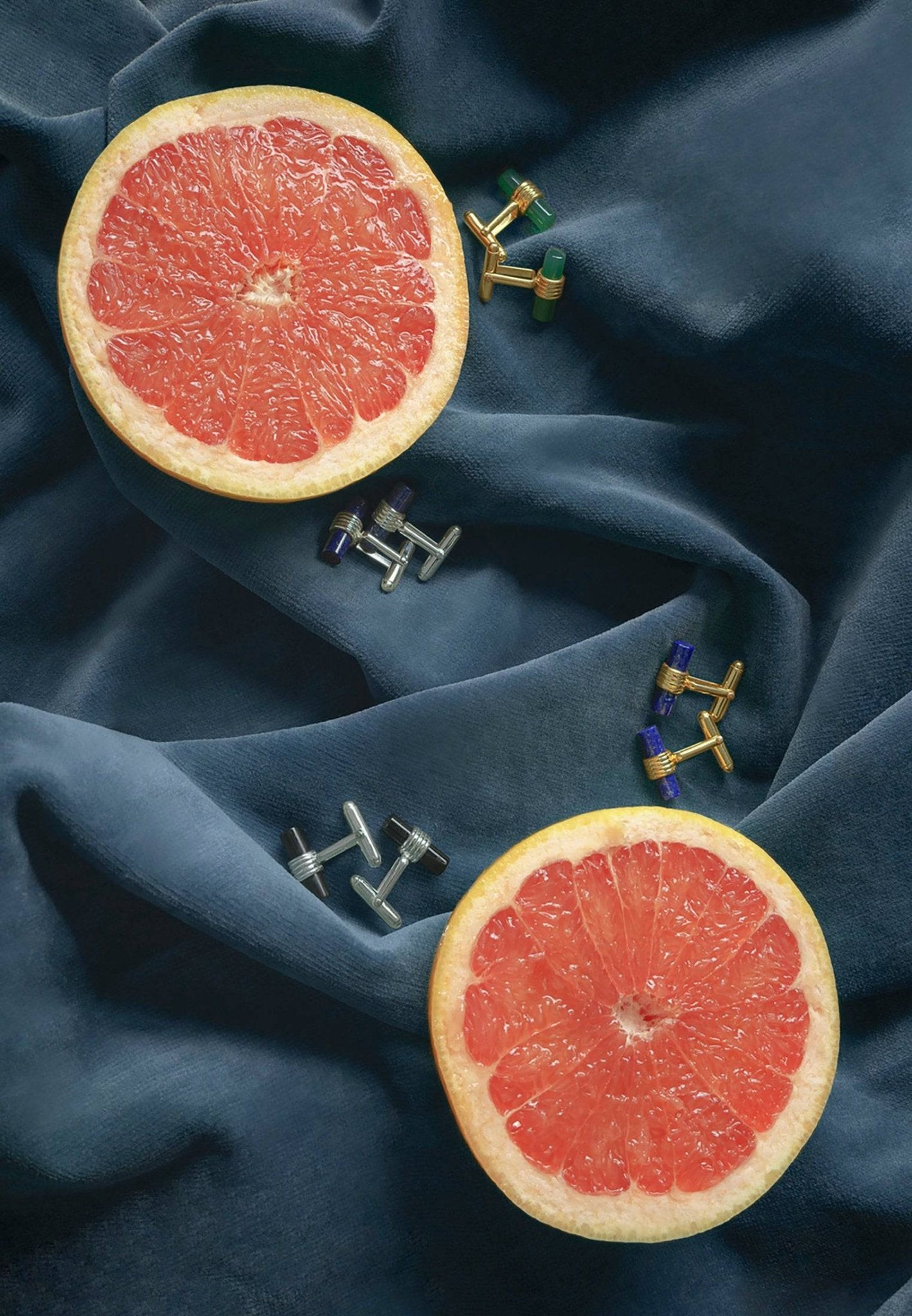 Elegant cylindrical cufflinks featuring gold and blue lapis lazuli, showcasing an art deco design.