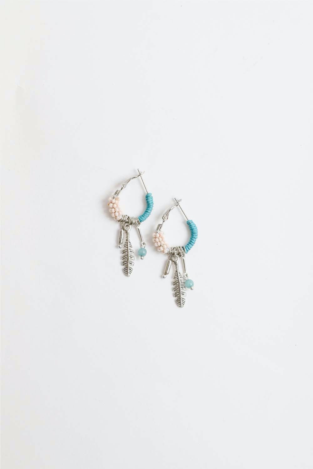 A pair of delicate Dainty Feather Hoop Earrings featuring a lightweight design, perfect for any occasion.