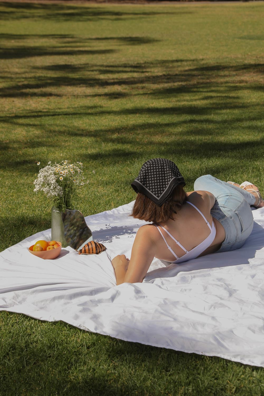 Daisy Flower Field Bandana featuring a vibrant floral print, styled as a hair wrap and neck scarf.