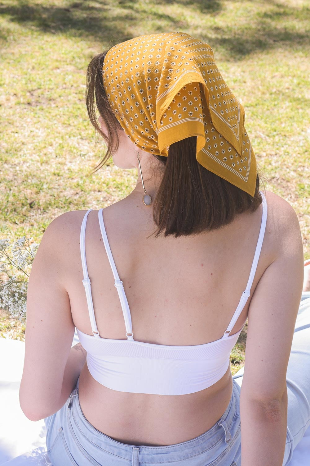 Daisy Flower Field Bandana featuring a vibrant floral print, styled as a hair wrap and neck scarf.