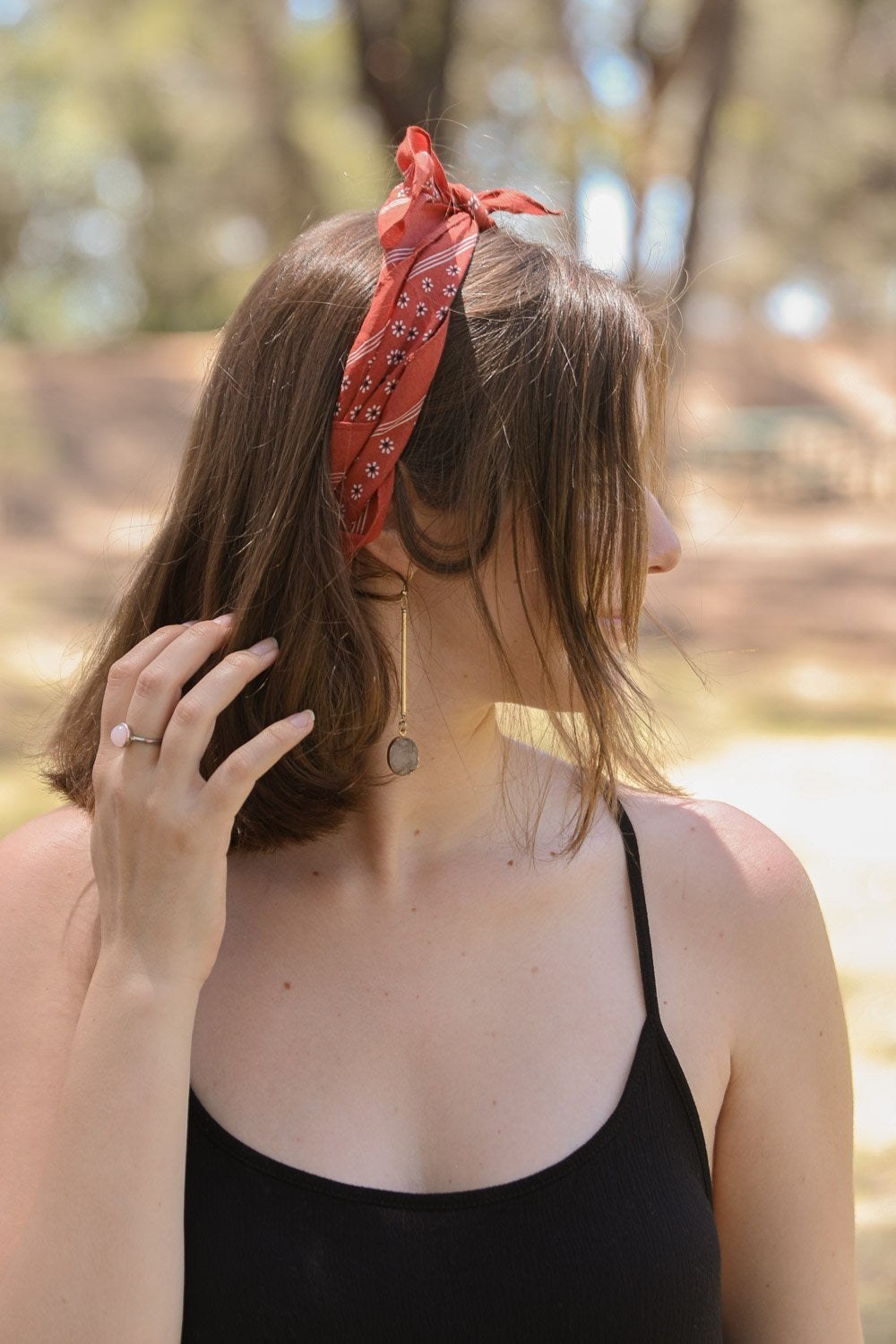 Daisy Flower Field Bandana featuring a vibrant floral print, styled as a hair wrap and neck scarf.