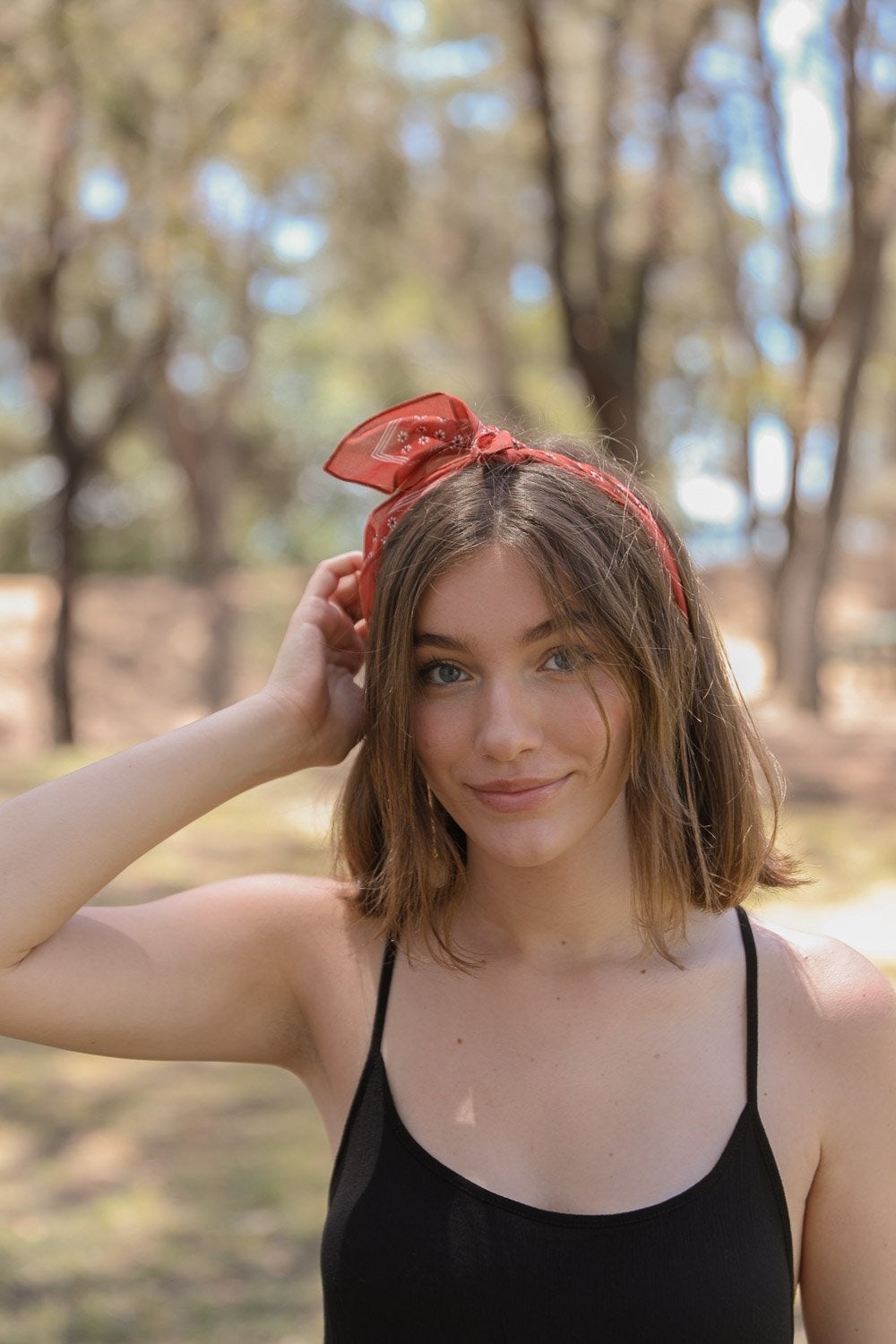 Daisy Flower Field Bandana featuring a vibrant floral print, styled as a hair wrap and neck scarf.