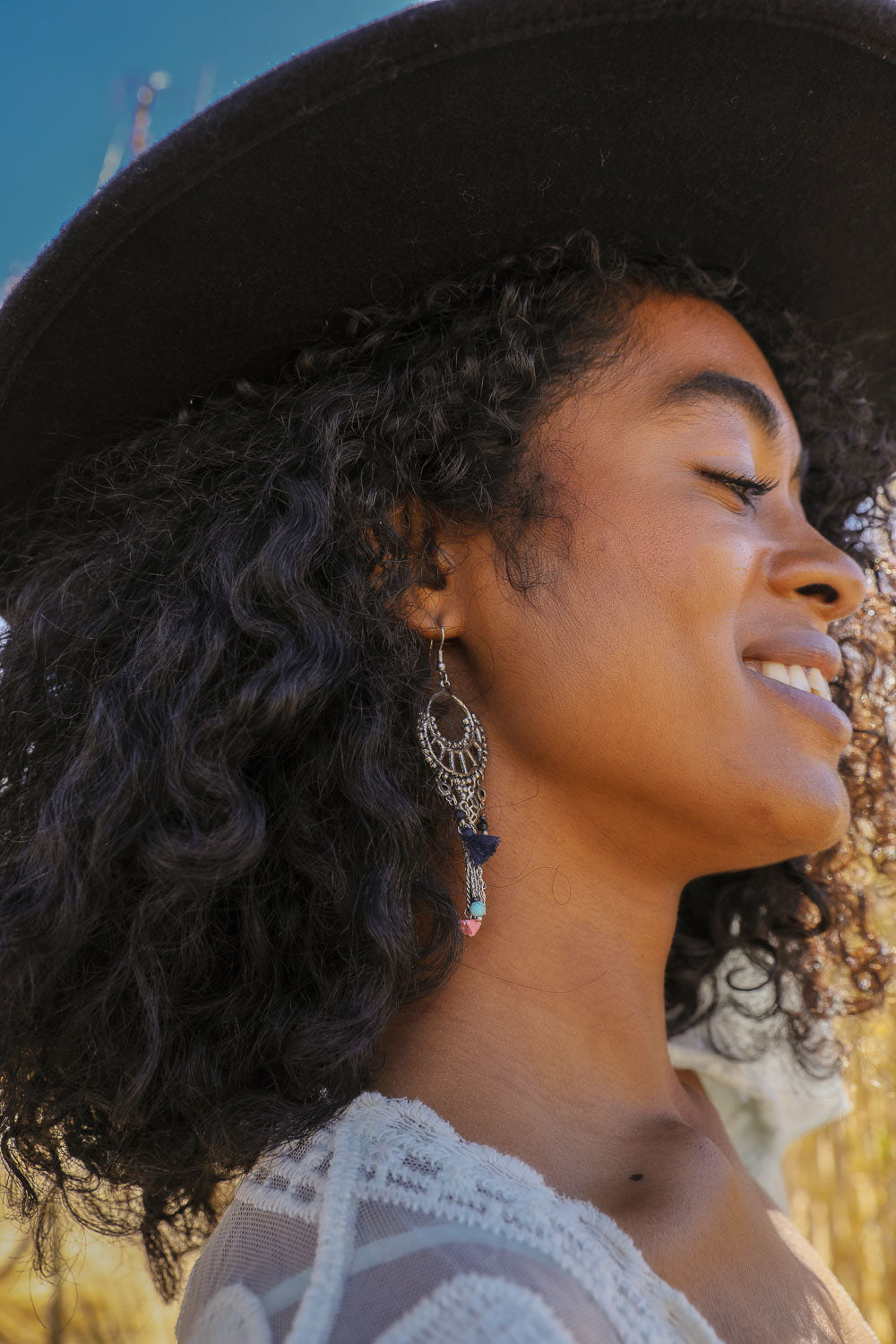 Dangling earrings featuring rose quartz beads and delicate fringe, showcasing elegance and style.