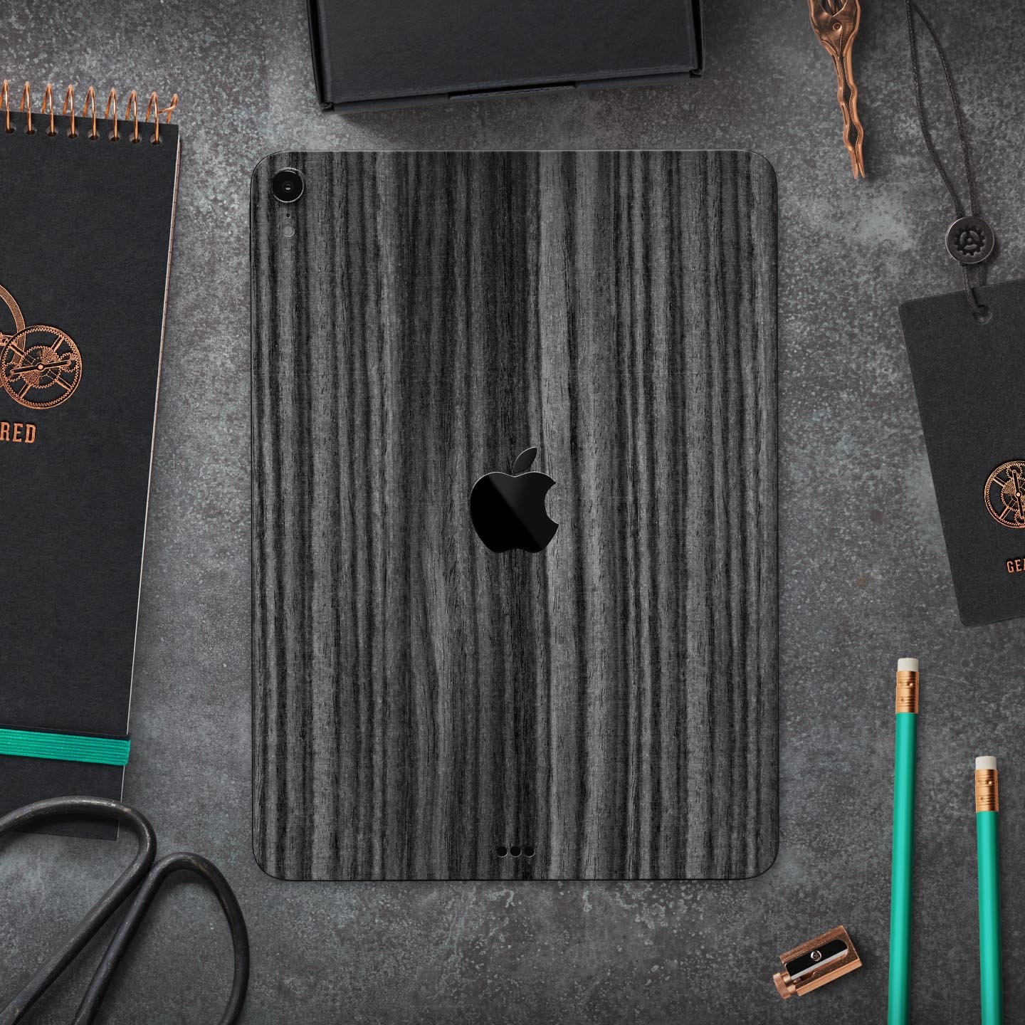 Dark Ebony Woodgrain skin decal for Apple iPad Pro, showcasing a sleek wood finish and precise cutouts for device features.