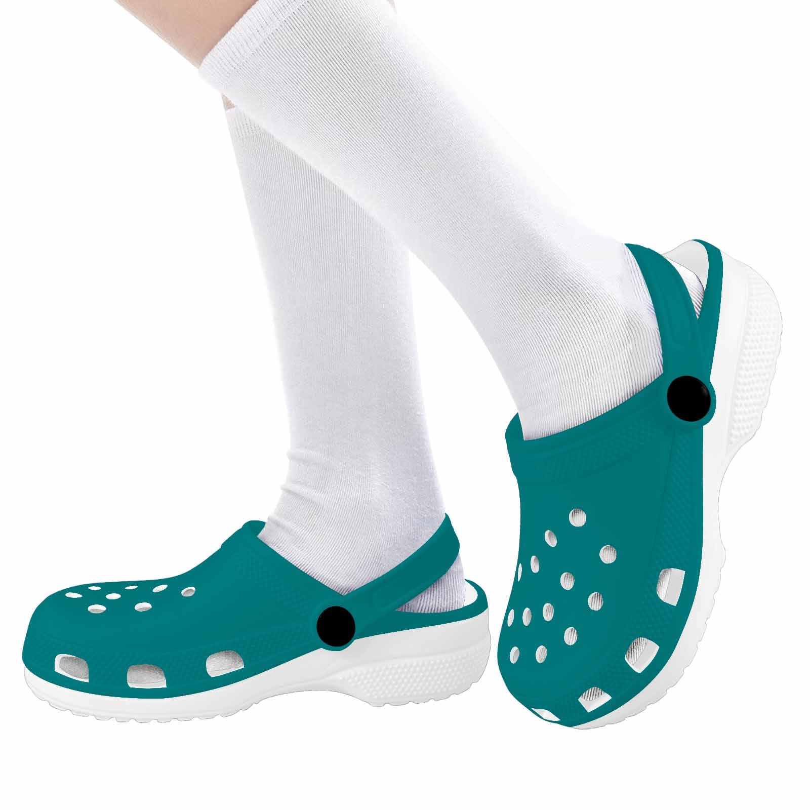 Dark teal green clogs designed for youth, featuring a slip-on style, breathable material, and cushioned sole for comfort.