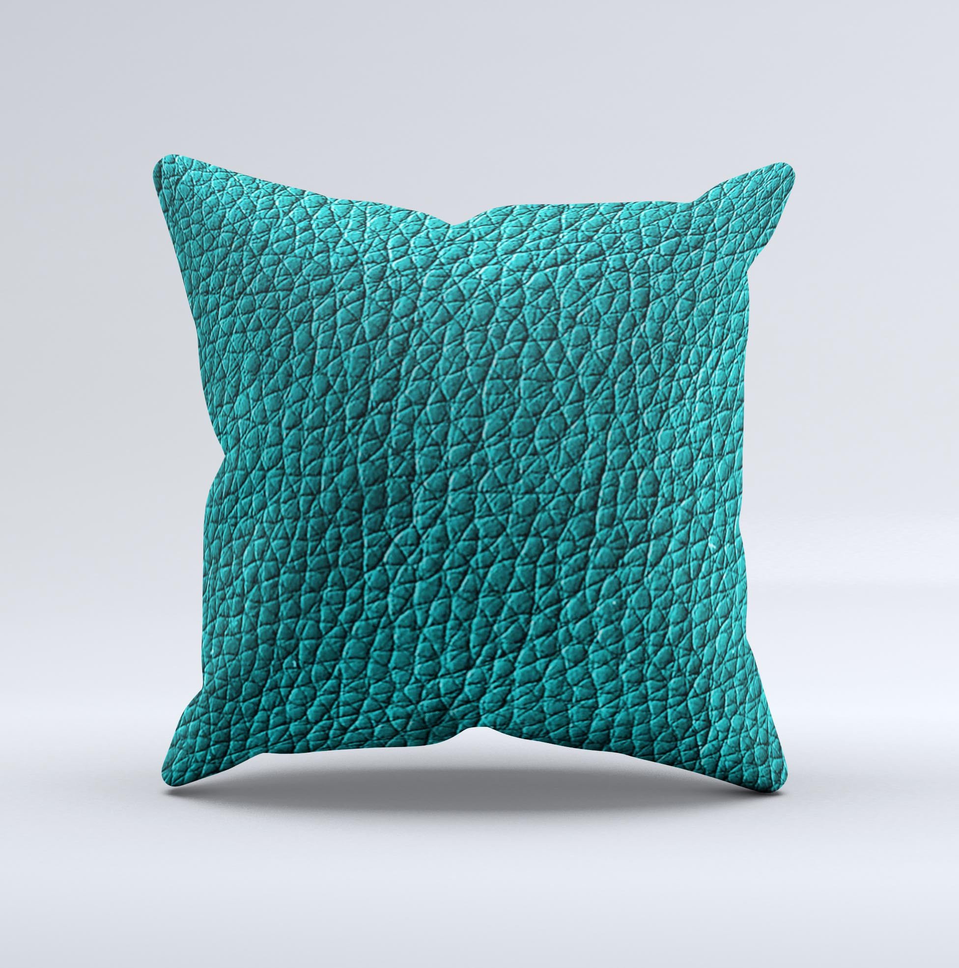 Dark teal leather decorative throw pillow with ink-fuzed design, handcrafted in Virginia, showcasing unique imperfections.