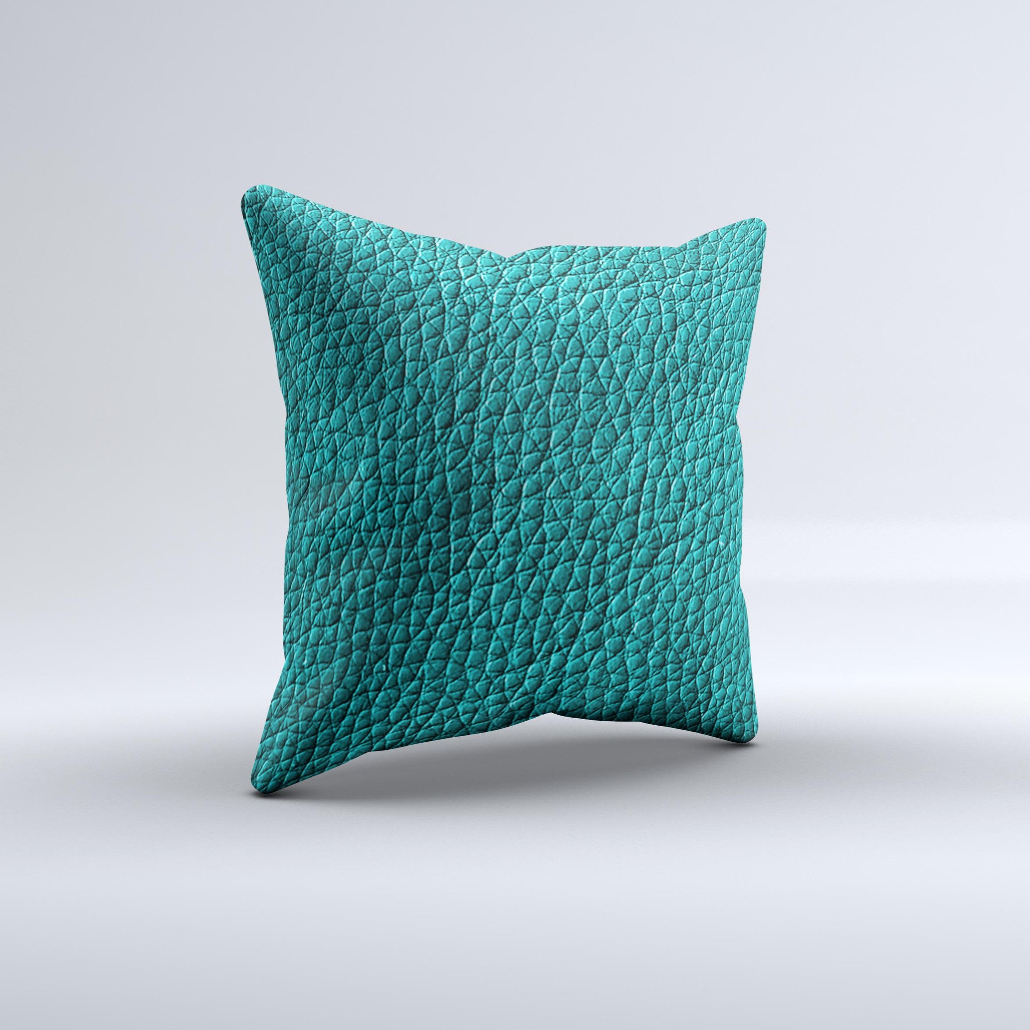 Dark teal leather decorative throw pillow with ink-fuzed design, handcrafted in Virginia, showcasing unique imperfections.