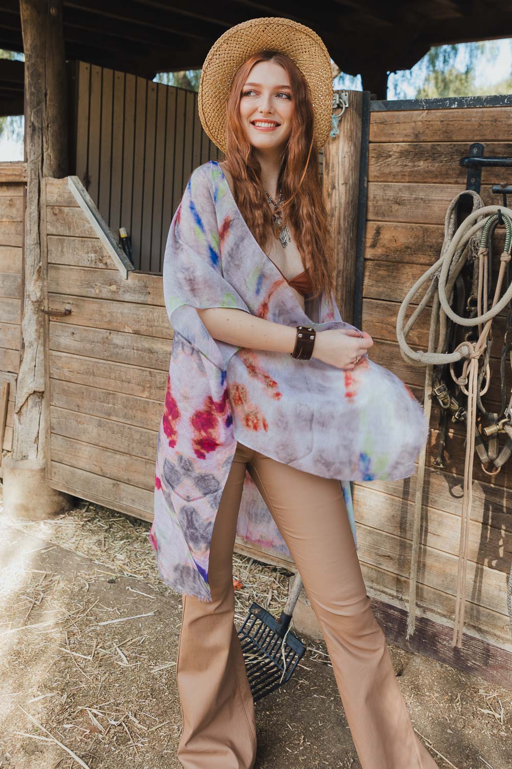 A vibrant Daydream Tie Dye Cover Up kimono featuring a colorful tie-dye pattern, perfect for music festivals and casual outings.