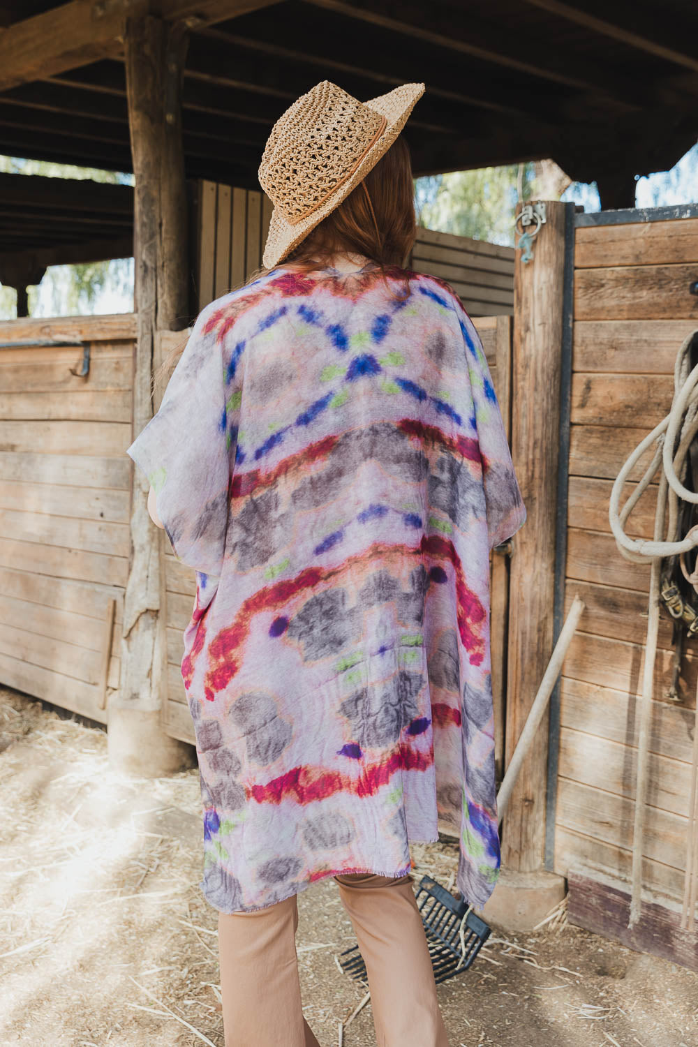 A vibrant Daydream Tie Dye Cover Up kimono featuring a colorful tie-dye pattern, perfect for music festivals and casual outings.