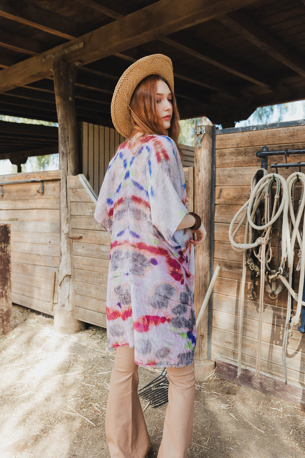 A vibrant Daydream Tie Dye Cover Up kimono featuring a colorful tie-dye pattern, perfect for music festivals and casual outings.