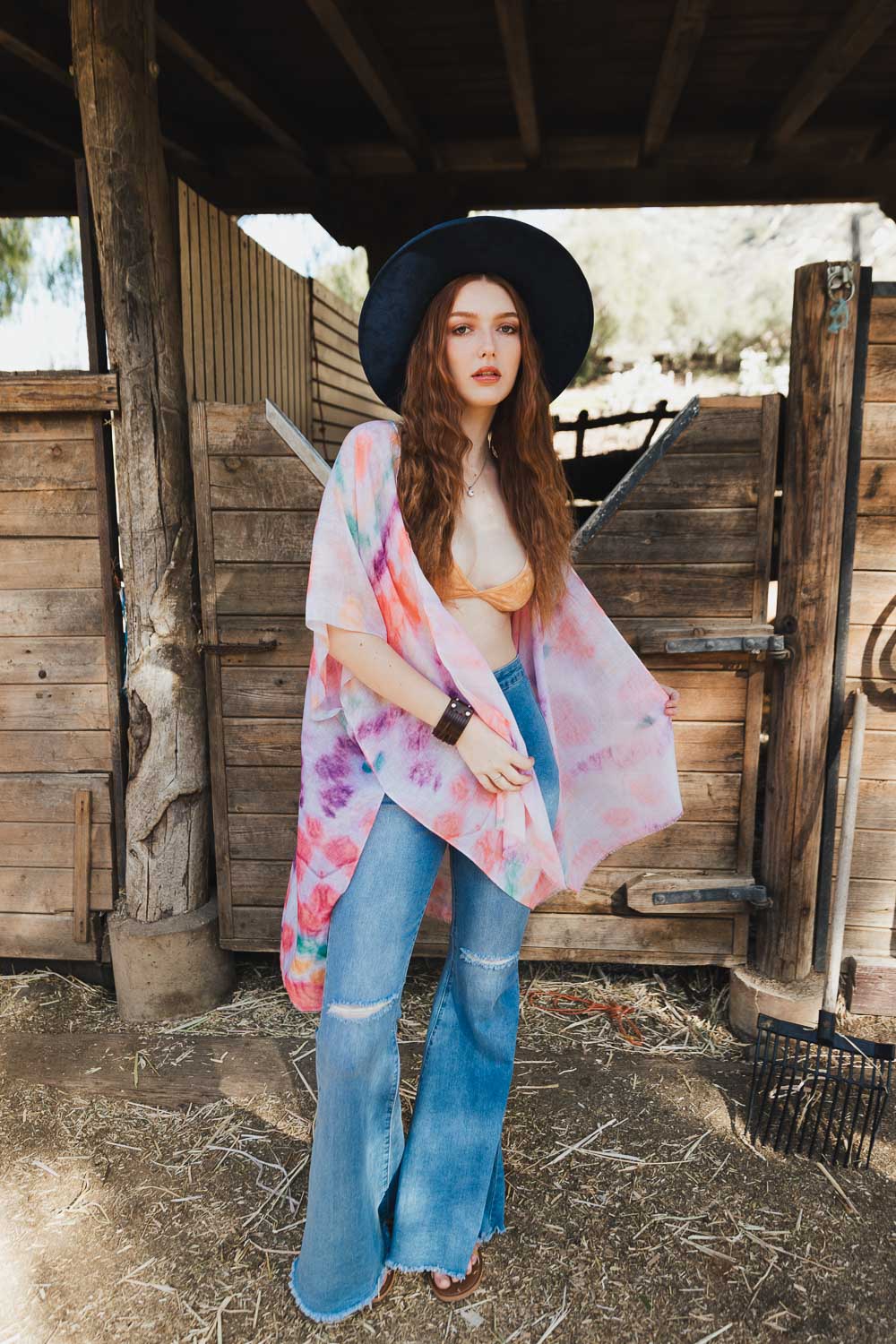 A vibrant Daydream Tie Dye Cover Up kimono featuring a colorful tie-dye pattern, perfect for music festivals and casual outings.