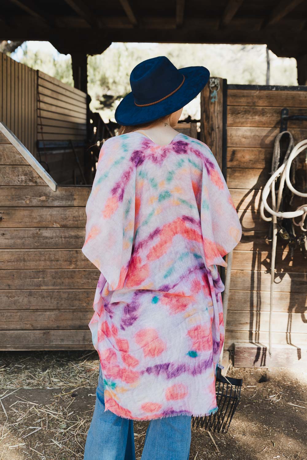 A vibrant Daydream Tie Dye Cover Up kimono featuring a colorful tie-dye pattern, perfect for music festivals and casual outings.