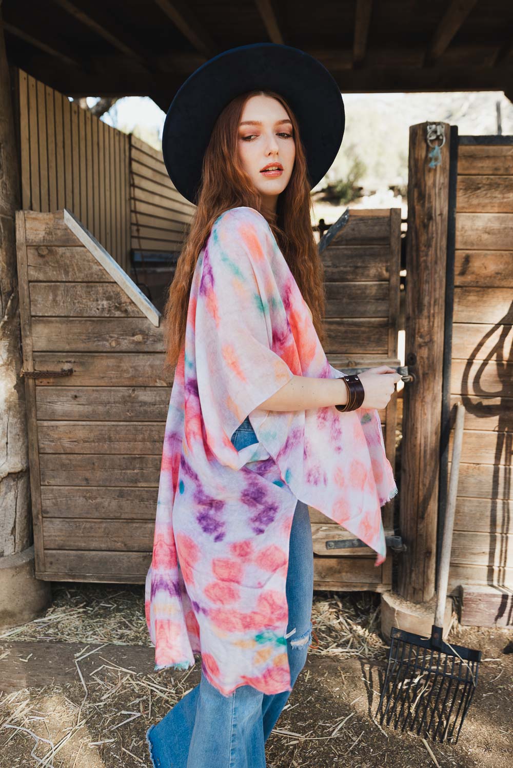 A vibrant Daydream Tie Dye Cover Up kimono featuring a colorful tie-dye pattern, perfect for music festivals and casual outings.