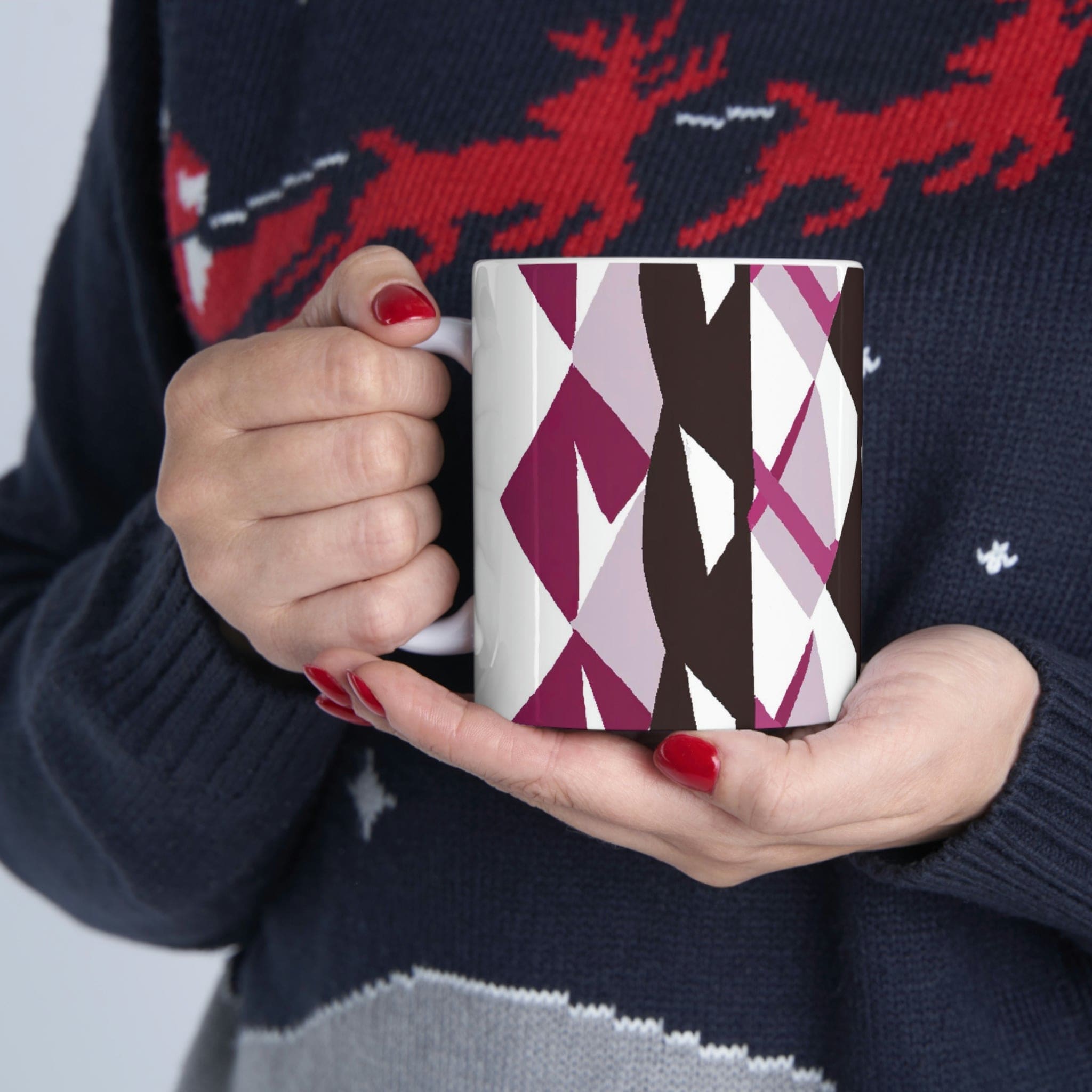 Decorative ceramic coffee mug in mauve pink and maroon geometric pattern, showcasing its elegant design and durable ceramic material.