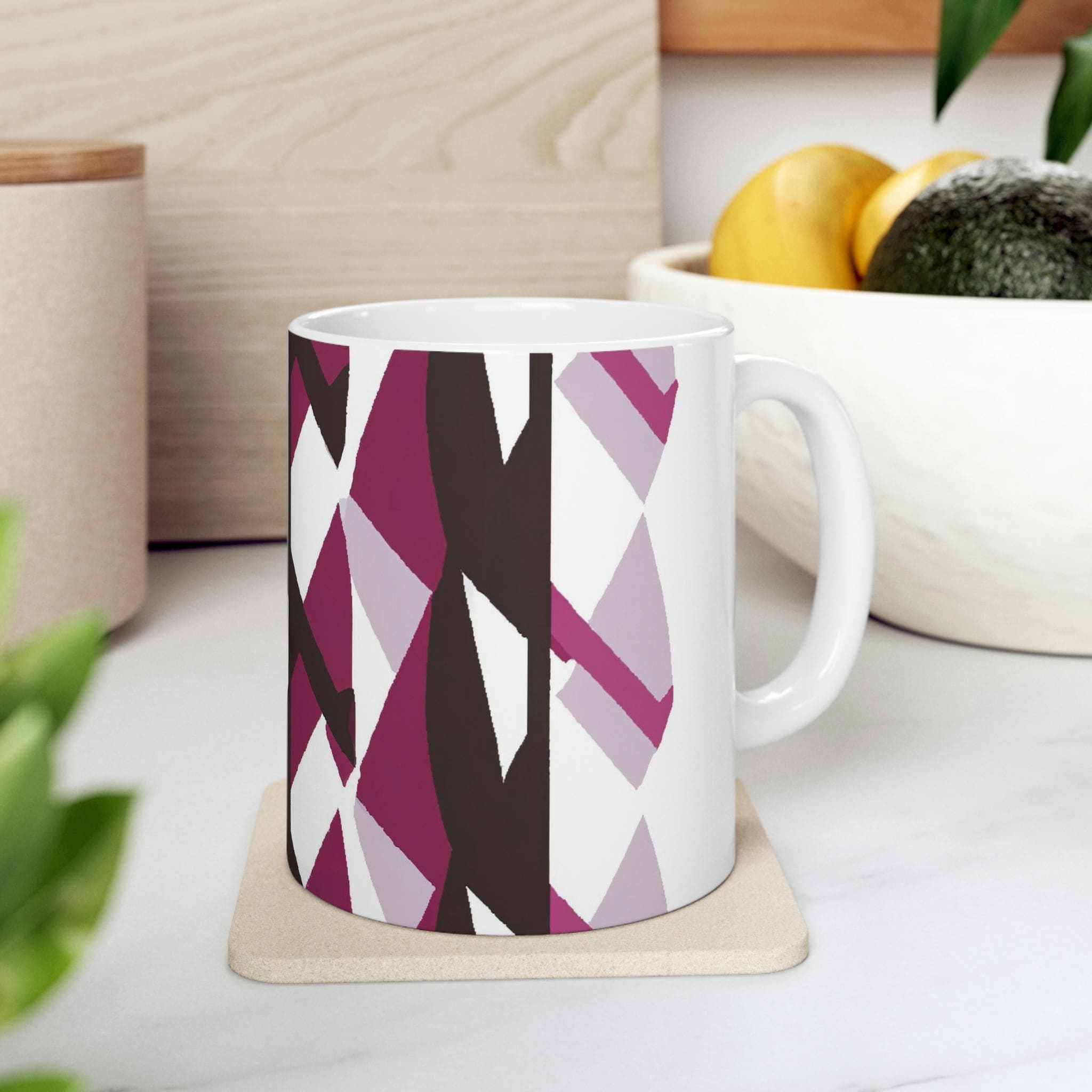 Decorative ceramic coffee mug in mauve pink and maroon geometric pattern, showcasing its elegant design and durable ceramic material.