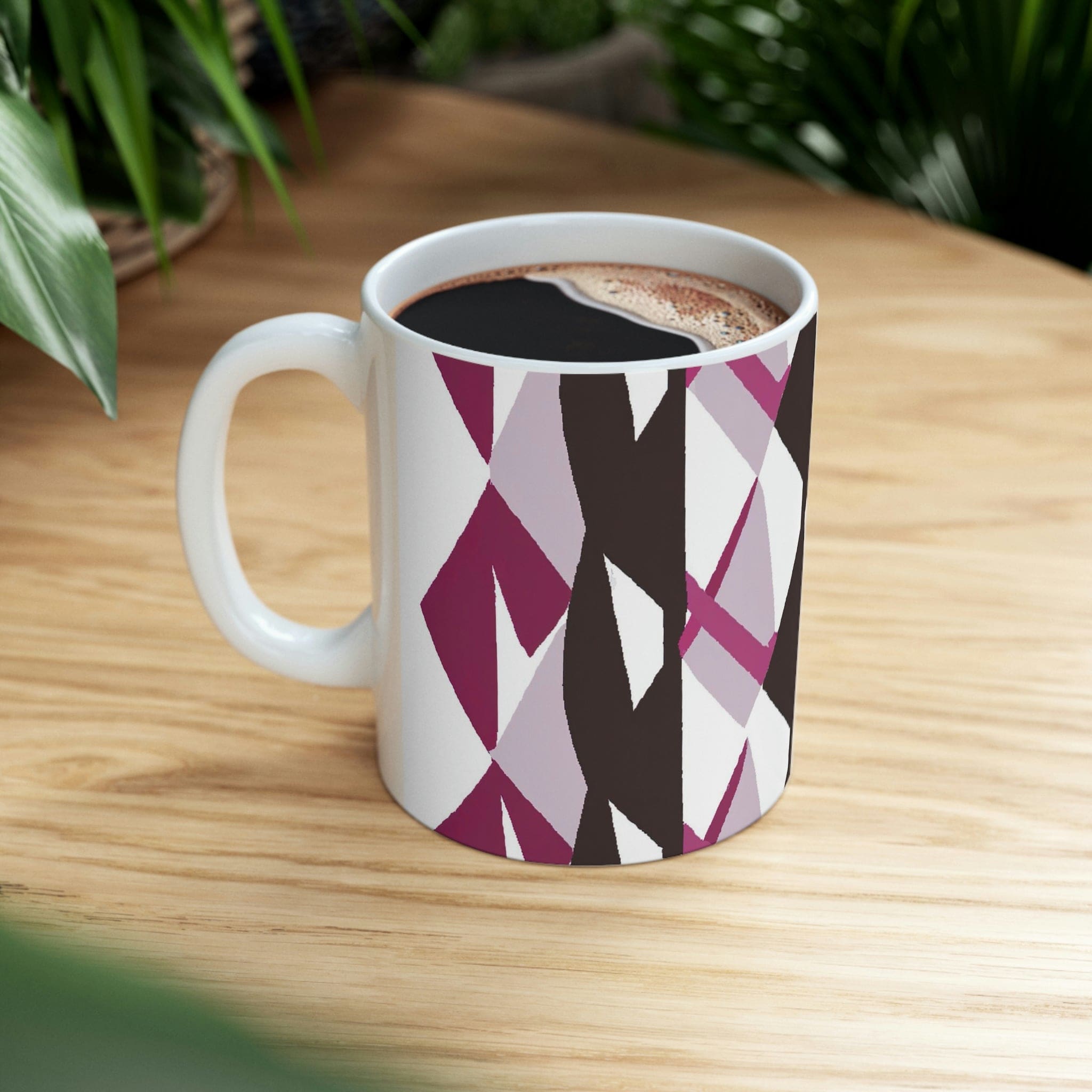 Decorative ceramic coffee mug in mauve pink and maroon geometric pattern, showcasing its elegant design and durable ceramic material.