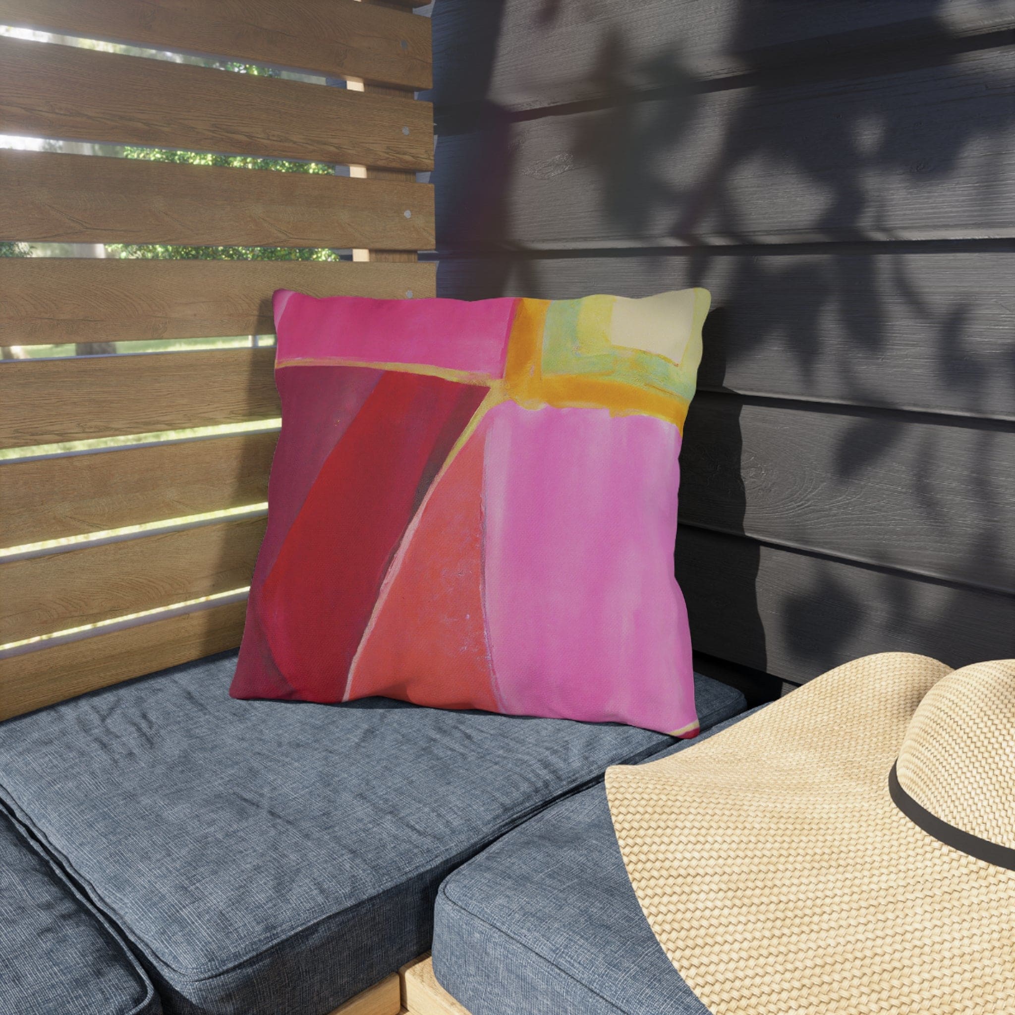 Decorative indoor/outdoor pillow featuring a pink mauve red geometric pattern, perfect for enhancing outdoor decor.