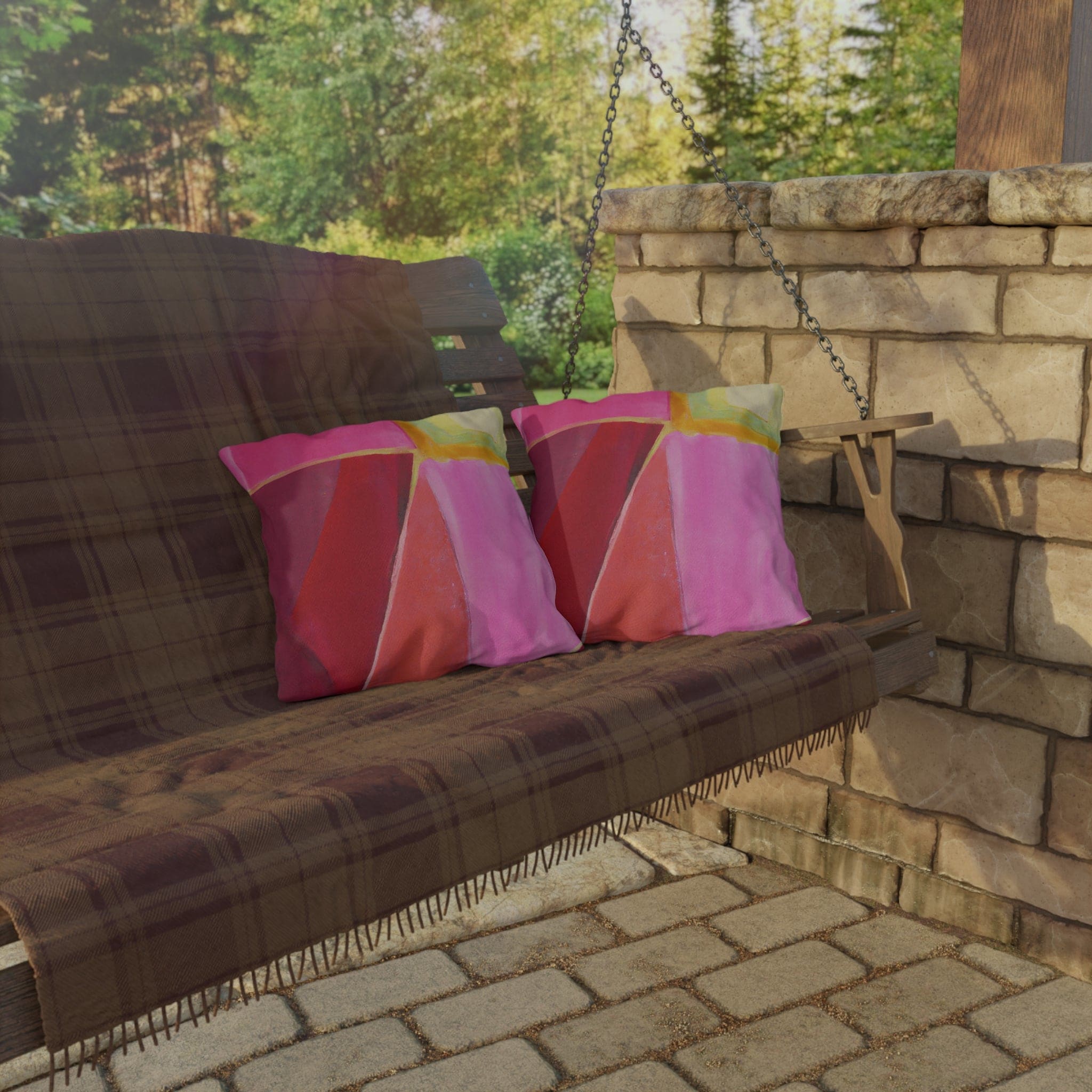 Decorative indoor/outdoor pillow featuring a pink mauve red geometric pattern, perfect for enhancing outdoor decor.