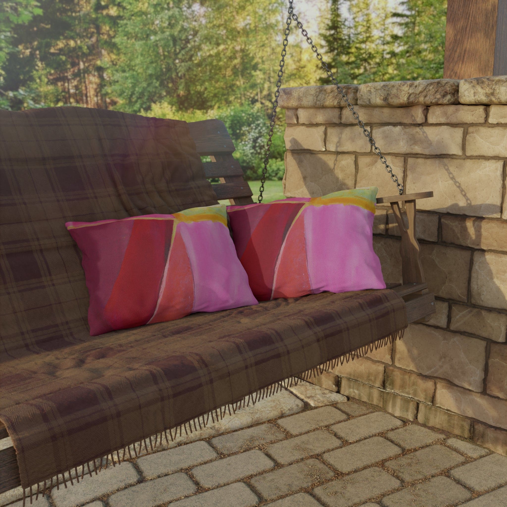 Decorative indoor/outdoor pillow featuring a pink mauve red geometric pattern, perfect for enhancing outdoor decor.