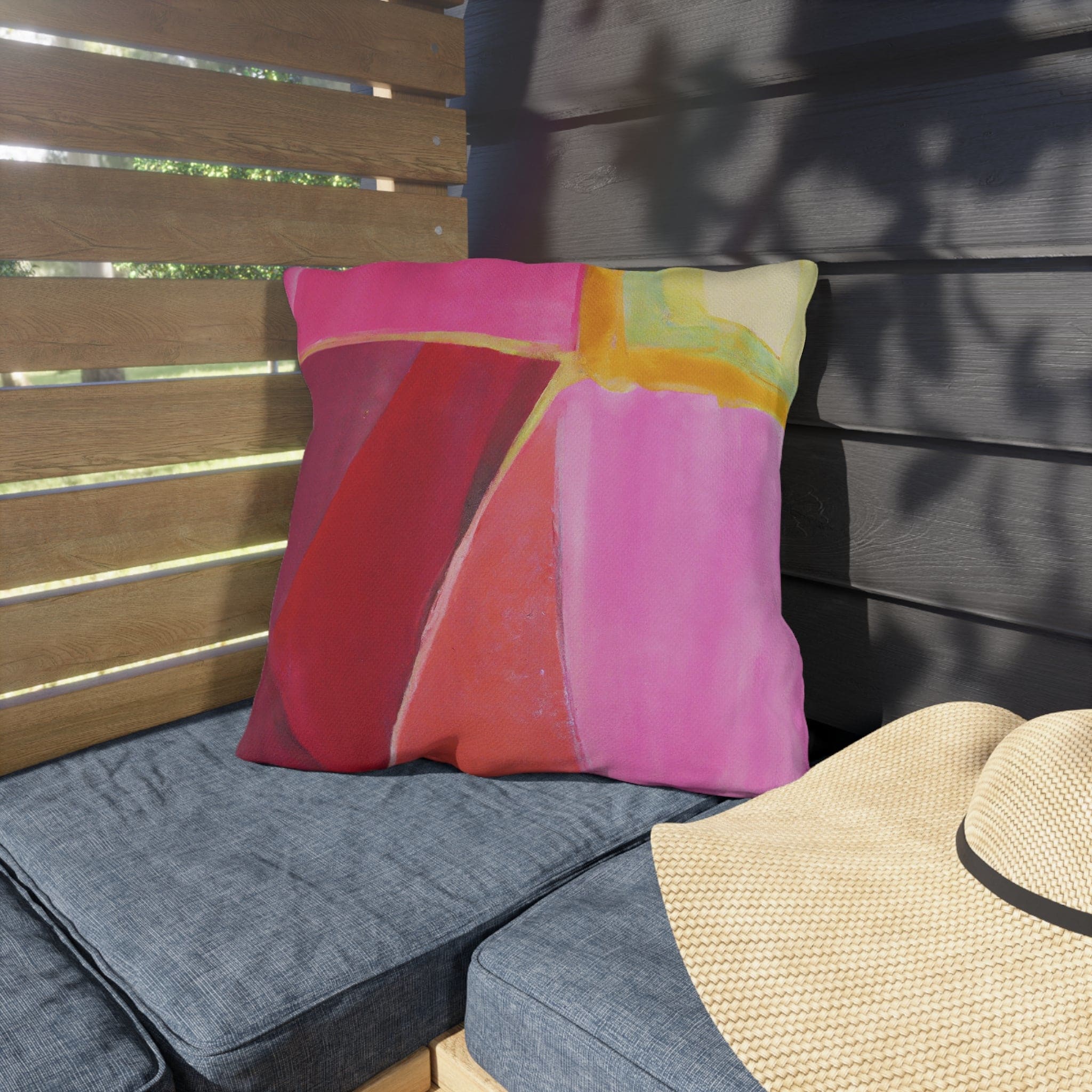 Decorative indoor/outdoor pillow featuring a pink mauve red geometric pattern, perfect for enhancing outdoor decor.