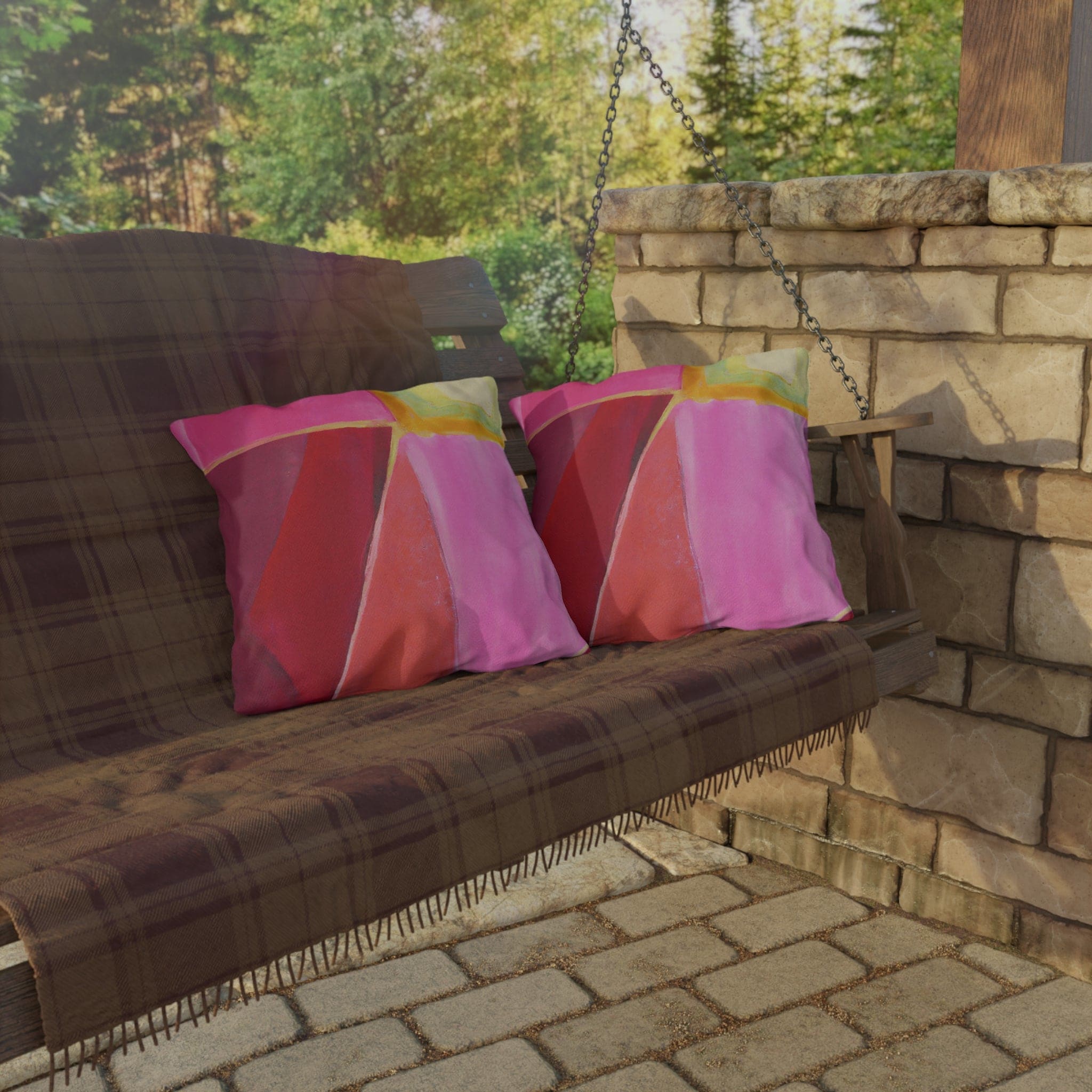 Decorative indoor/outdoor pillow featuring a pink mauve red geometric pattern, perfect for enhancing outdoor decor.