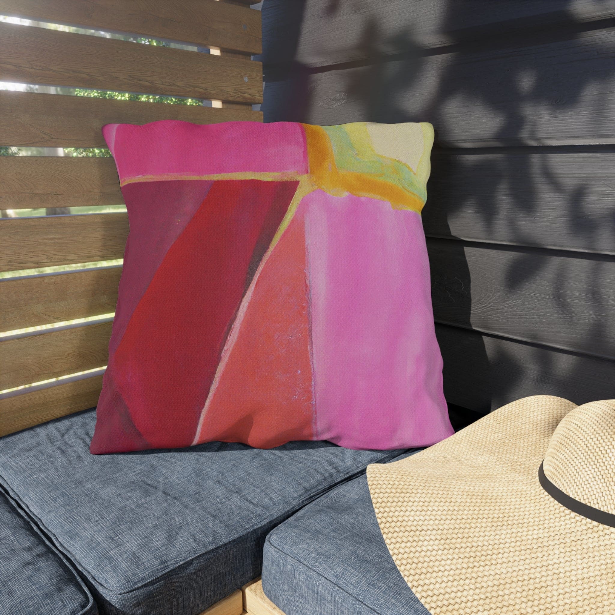 Decorative indoor/outdoor pillow featuring a pink mauve red geometric pattern, perfect for enhancing outdoor decor.