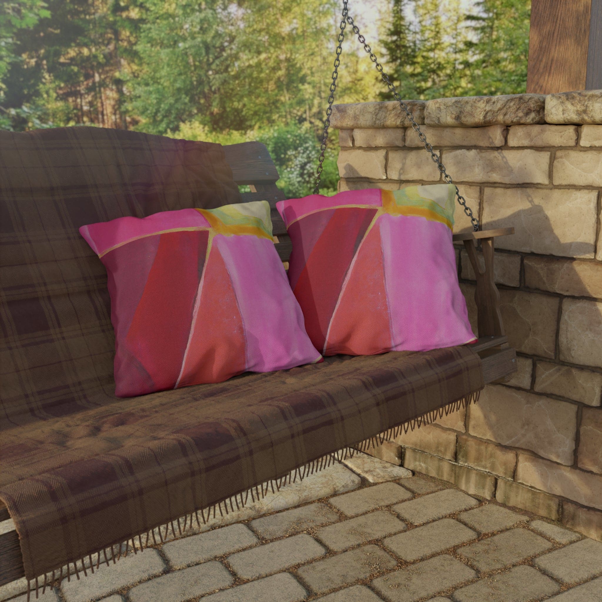 Decorative indoor/outdoor pillow featuring a pink mauve red geometric pattern, perfect for enhancing outdoor decor.