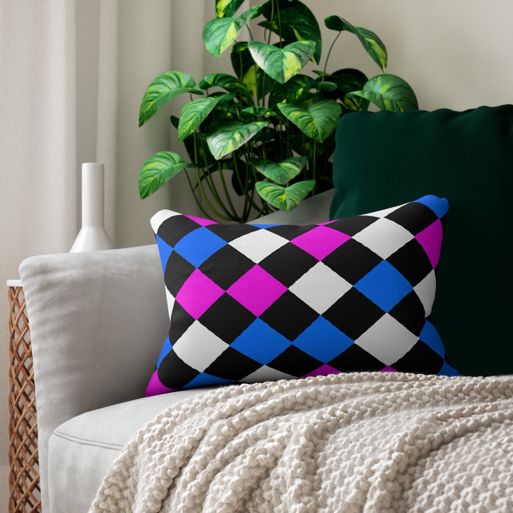 Decorative lumbar throw pillow featuring a vibrant black, pink, and blue checkered pattern, ideal for enhancing home decor.